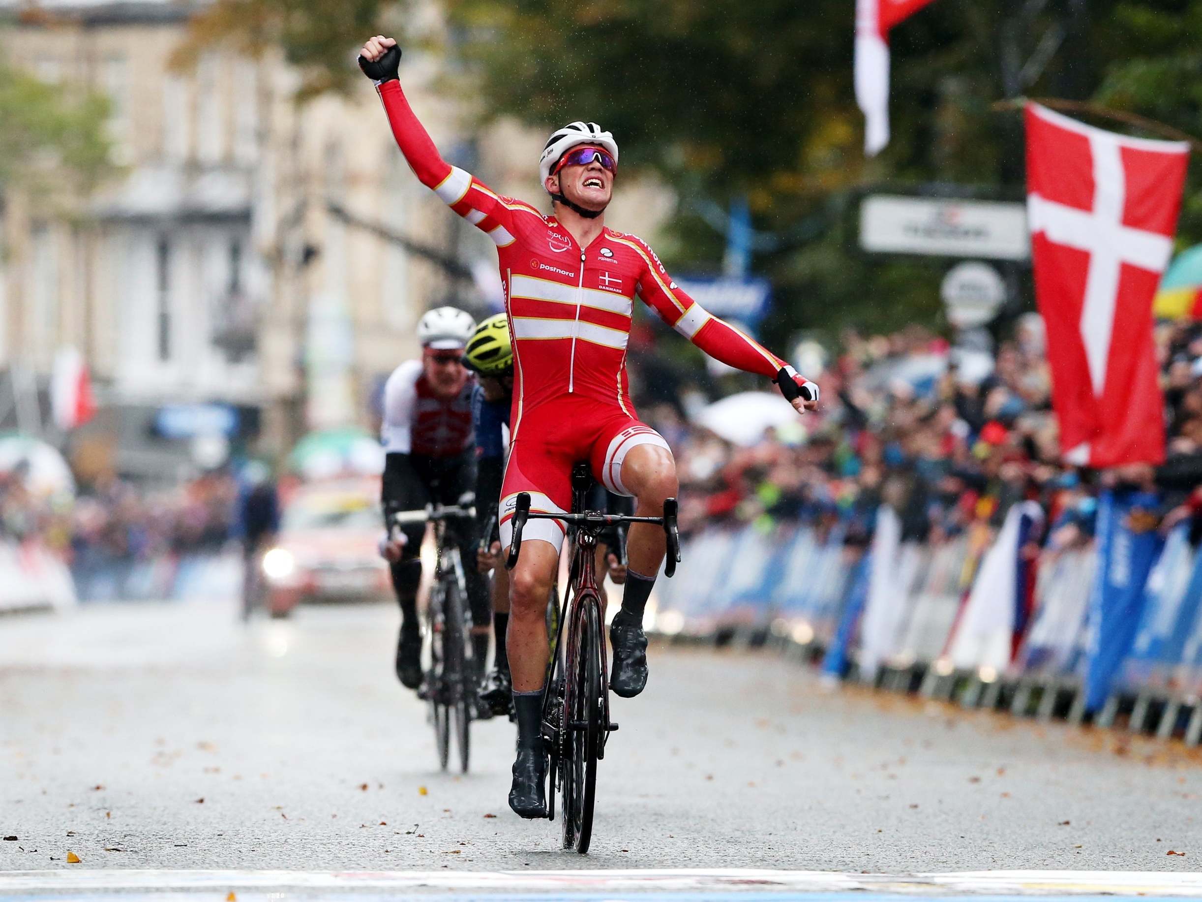 Mads Pedersen celebrates as he crosses the finish line