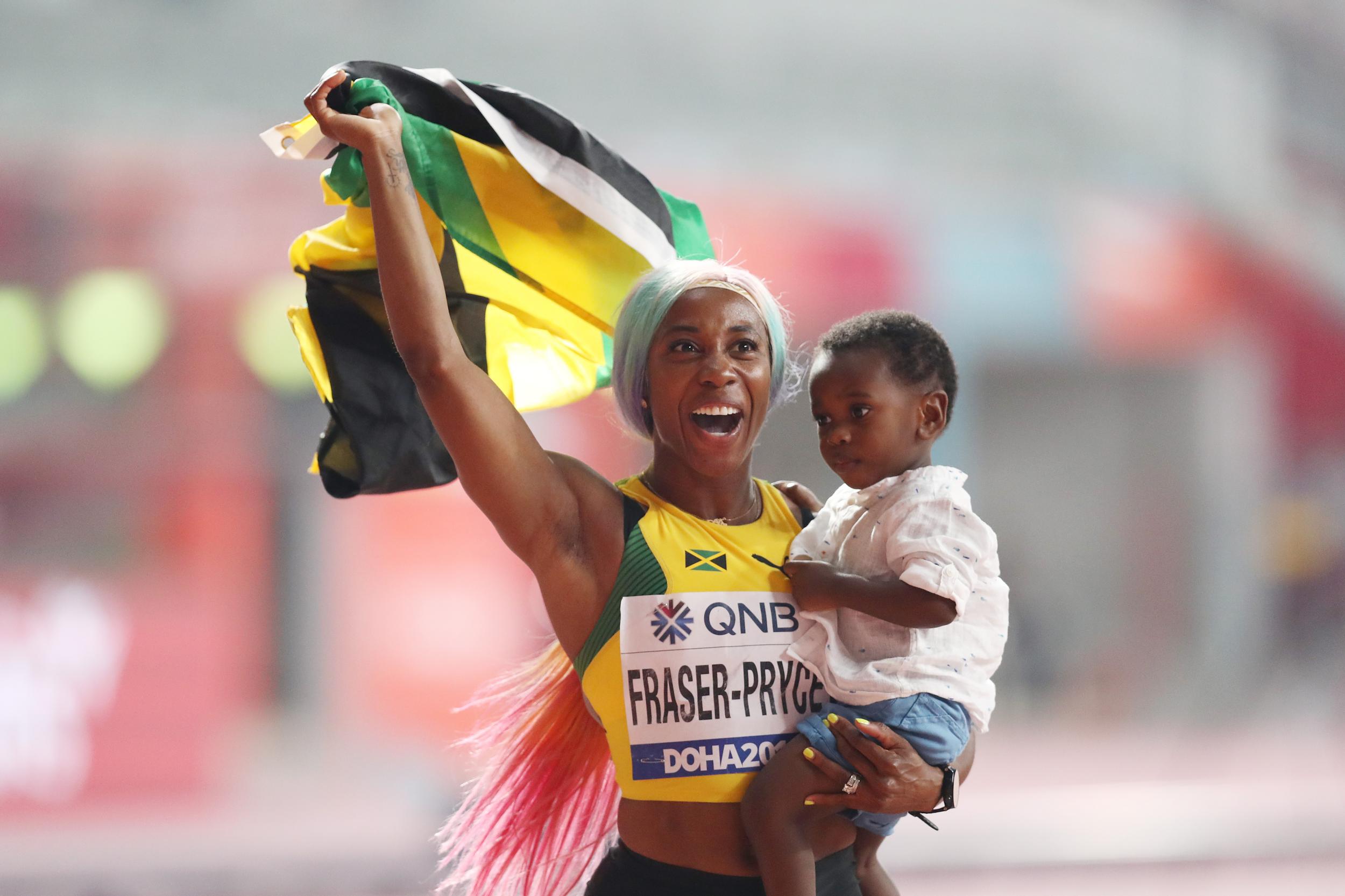 Shelly-Ann Fraser-Pryce celebrates with her son after winning the 100m final