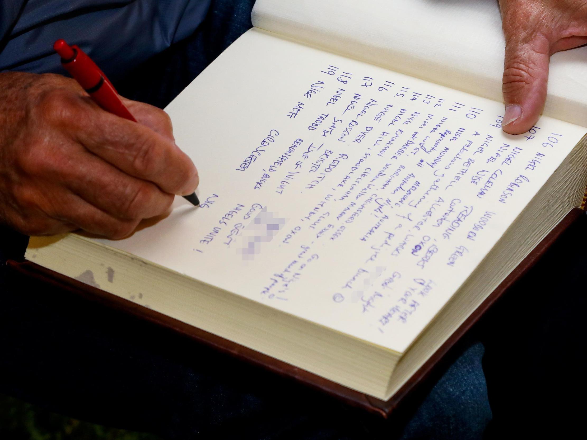 Attendees signing the ‘Book of Nigel’