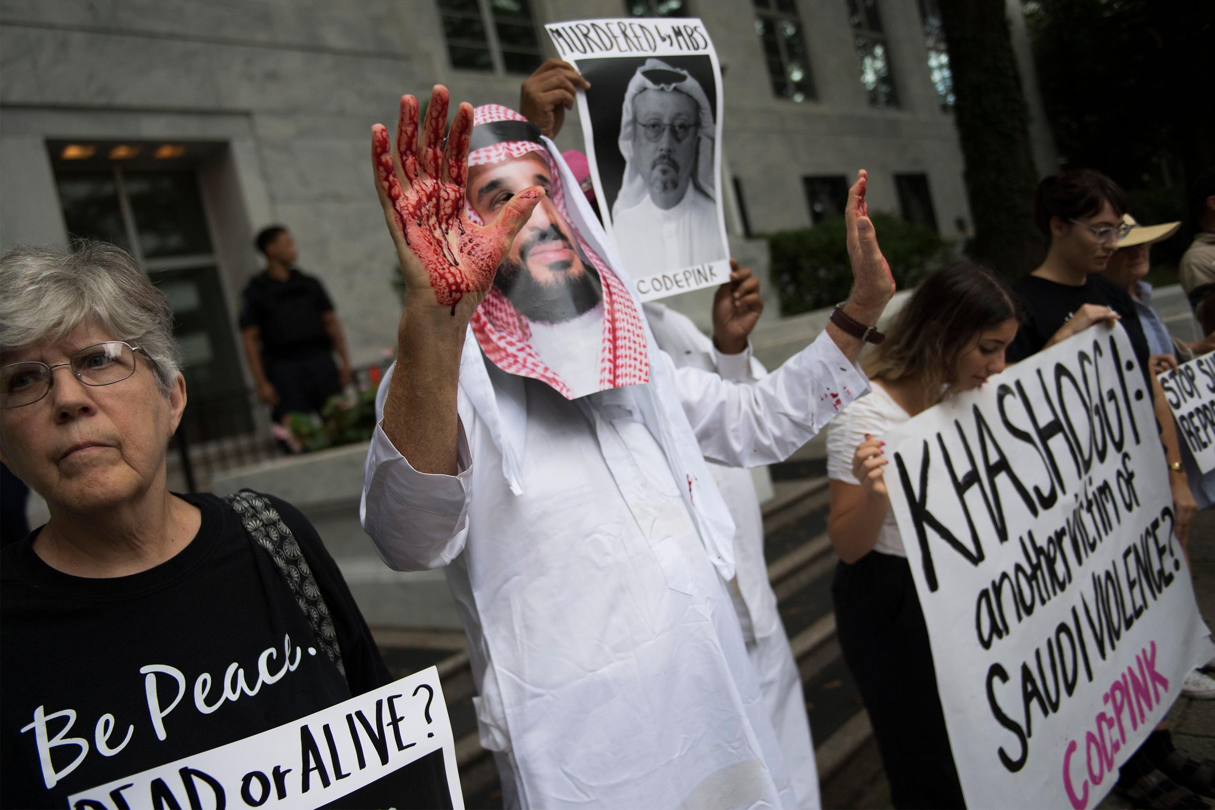 A demonstrator dressed as Mohammed bin Salman with blood on his hands. MbS denies ordering the killing of Khashoggi (AFP/Getty)