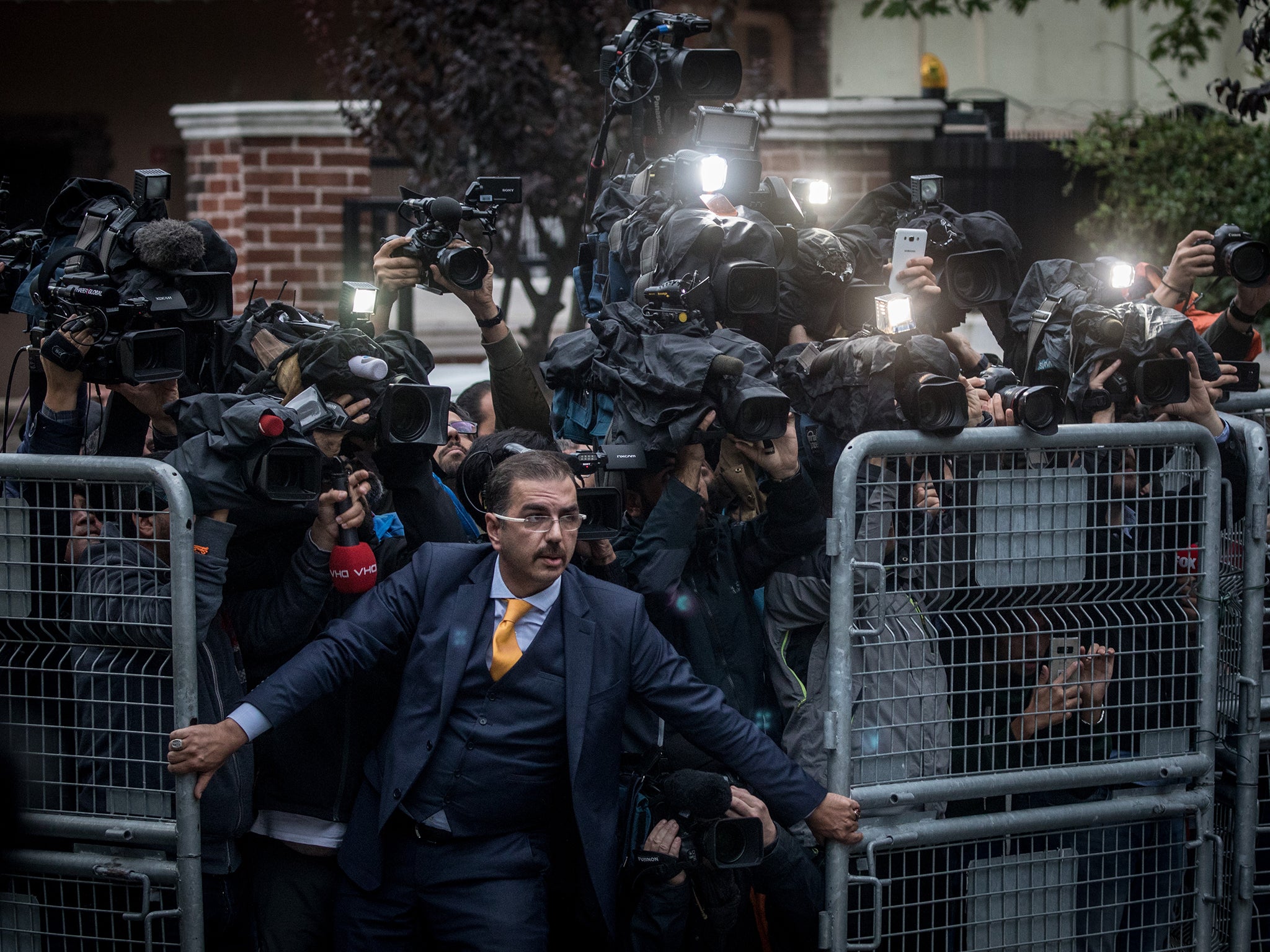 A man holds back the press outside the Saudi Arabian consulate in Istanbul last October, when Khashoggi was still missing