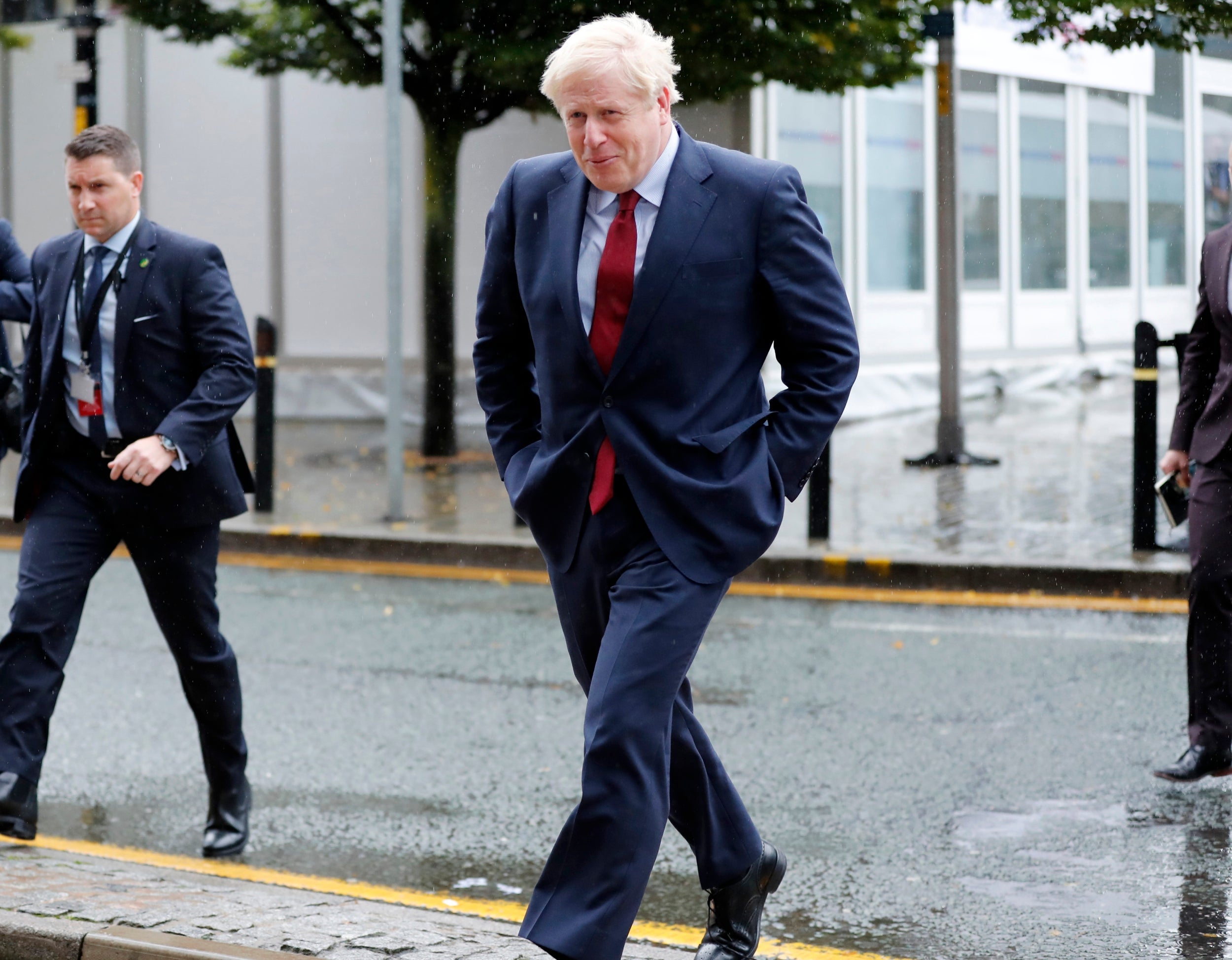 The prime minister gets caught in the rain in Manchester