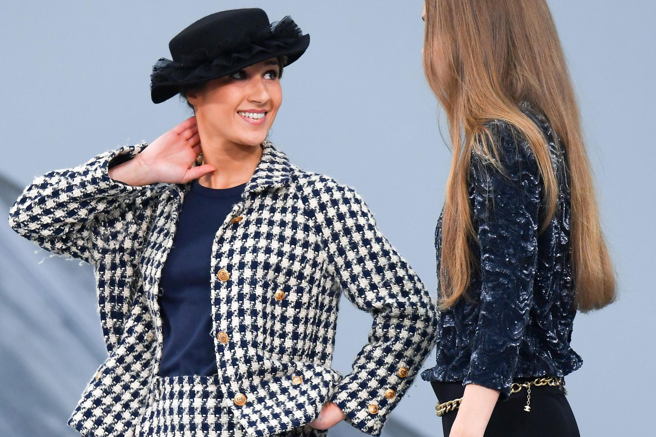 Gigi Hadid approaches prankster Marie Benoliel aka Marie S'Infiltre and escorts her off the catwalkduring the Chanel show at Paris Fashion Week.