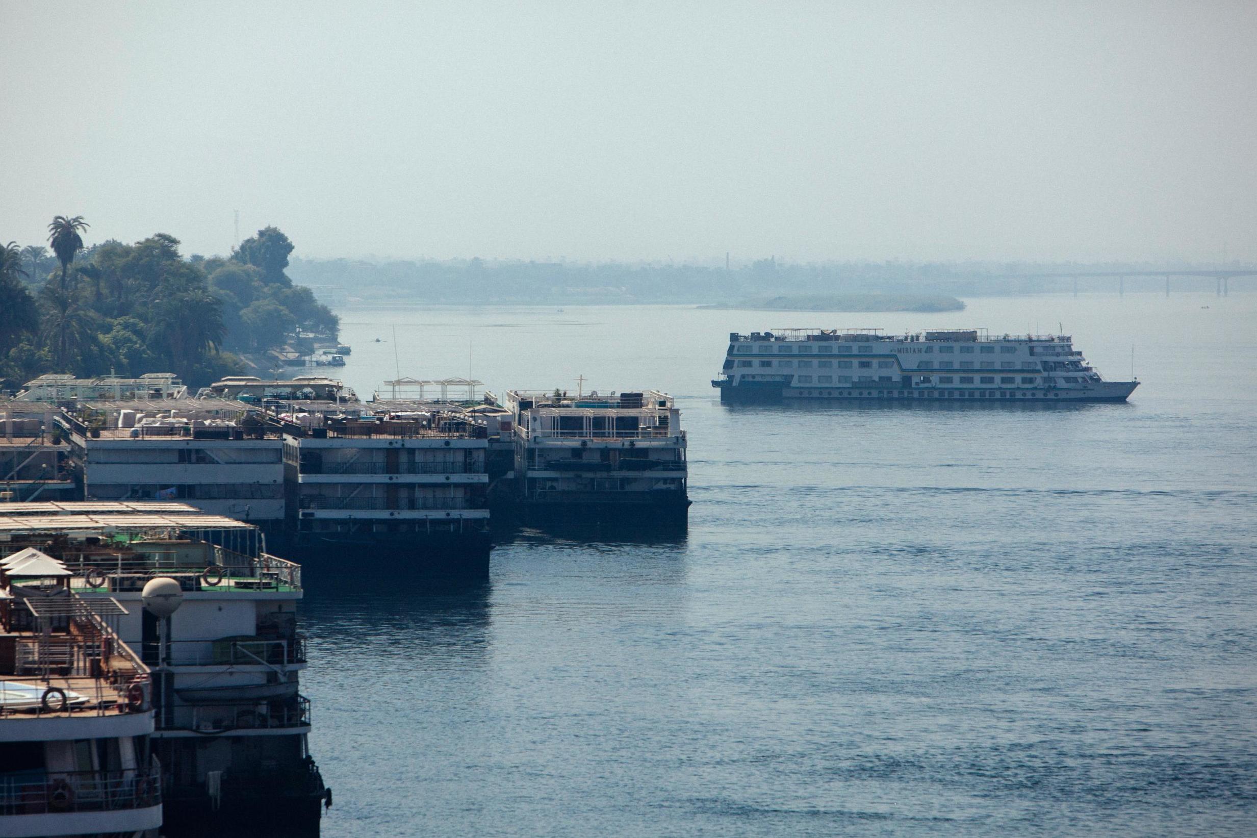 Boats dock along the Nile River shoreline in Luxor