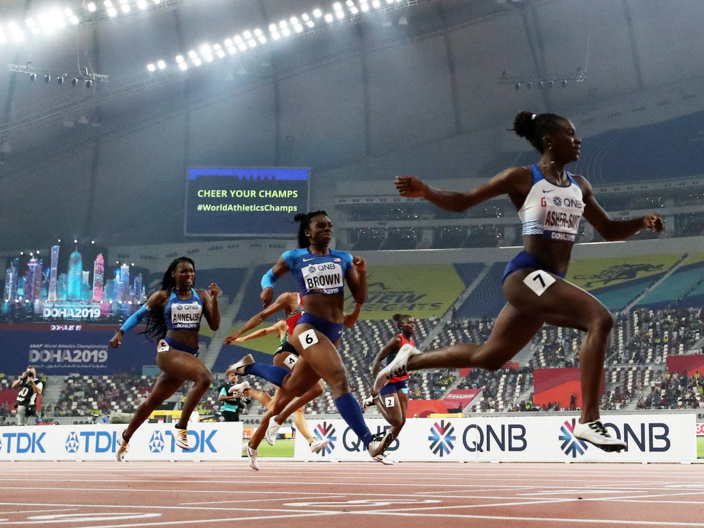 Dina Asher-Smith crosses the line to win gold