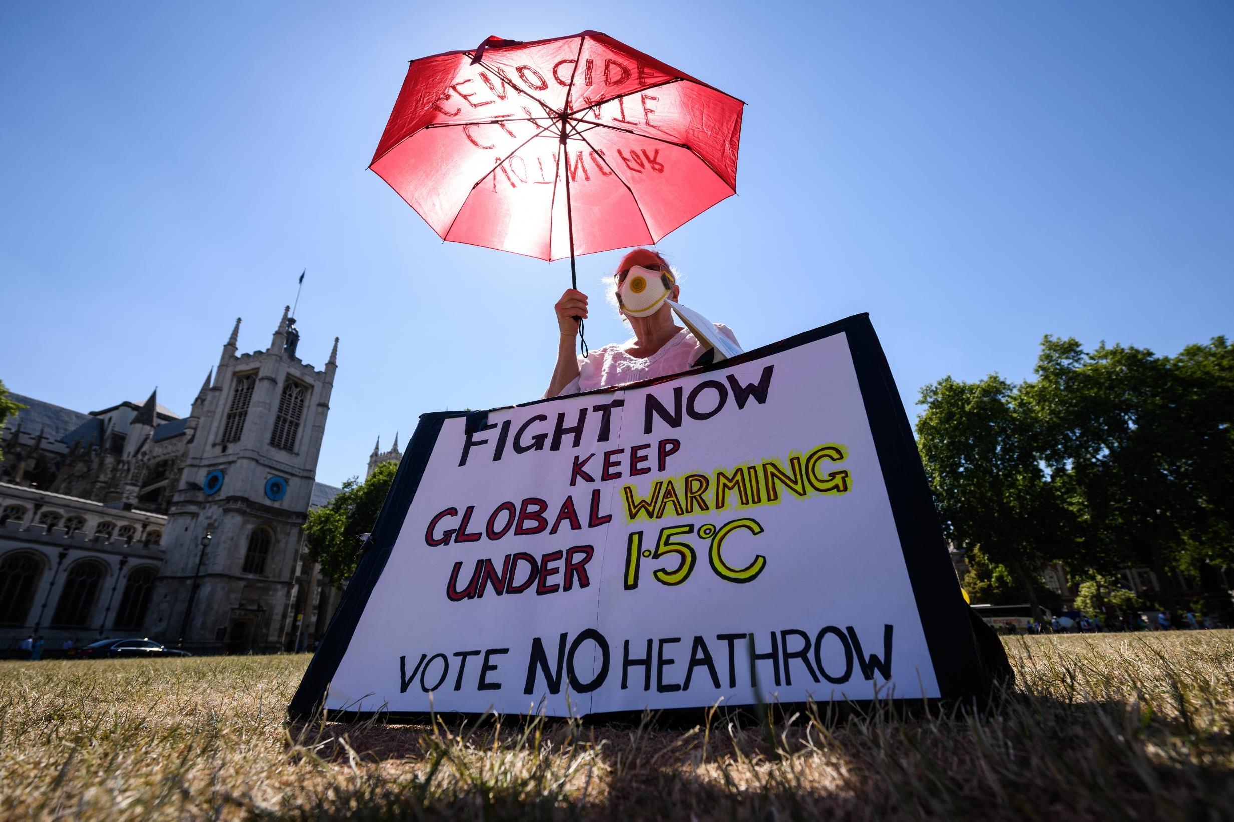 Environmental campaigner Genni Scherer protesting against a proposed third runway at Heathrow airport, already the biggest single source of greenhouse gases in the UK, outside the House of Parliament