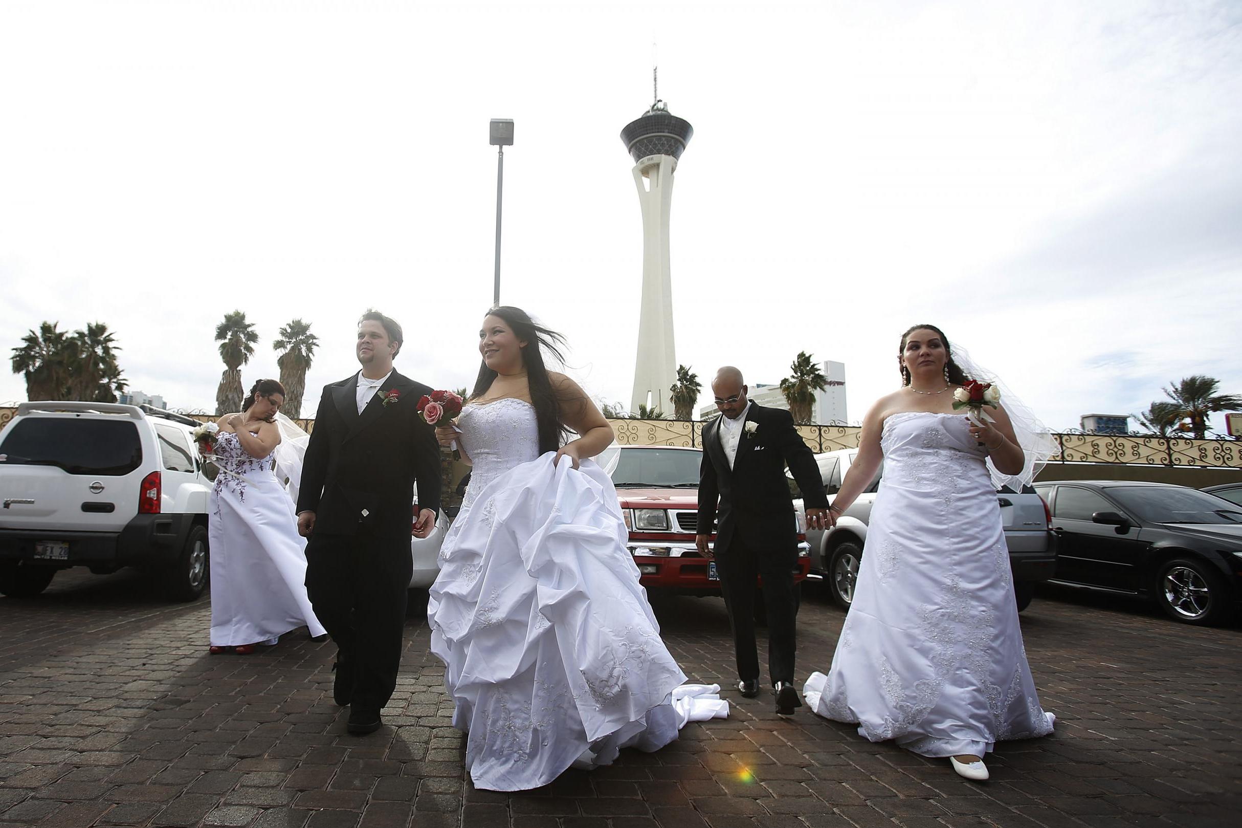 Newlyweds await their photographs outside the Little Chapel of the Flowers in Las Vegas – the Nevada city is one of the most popular destinations for an overseas wedding