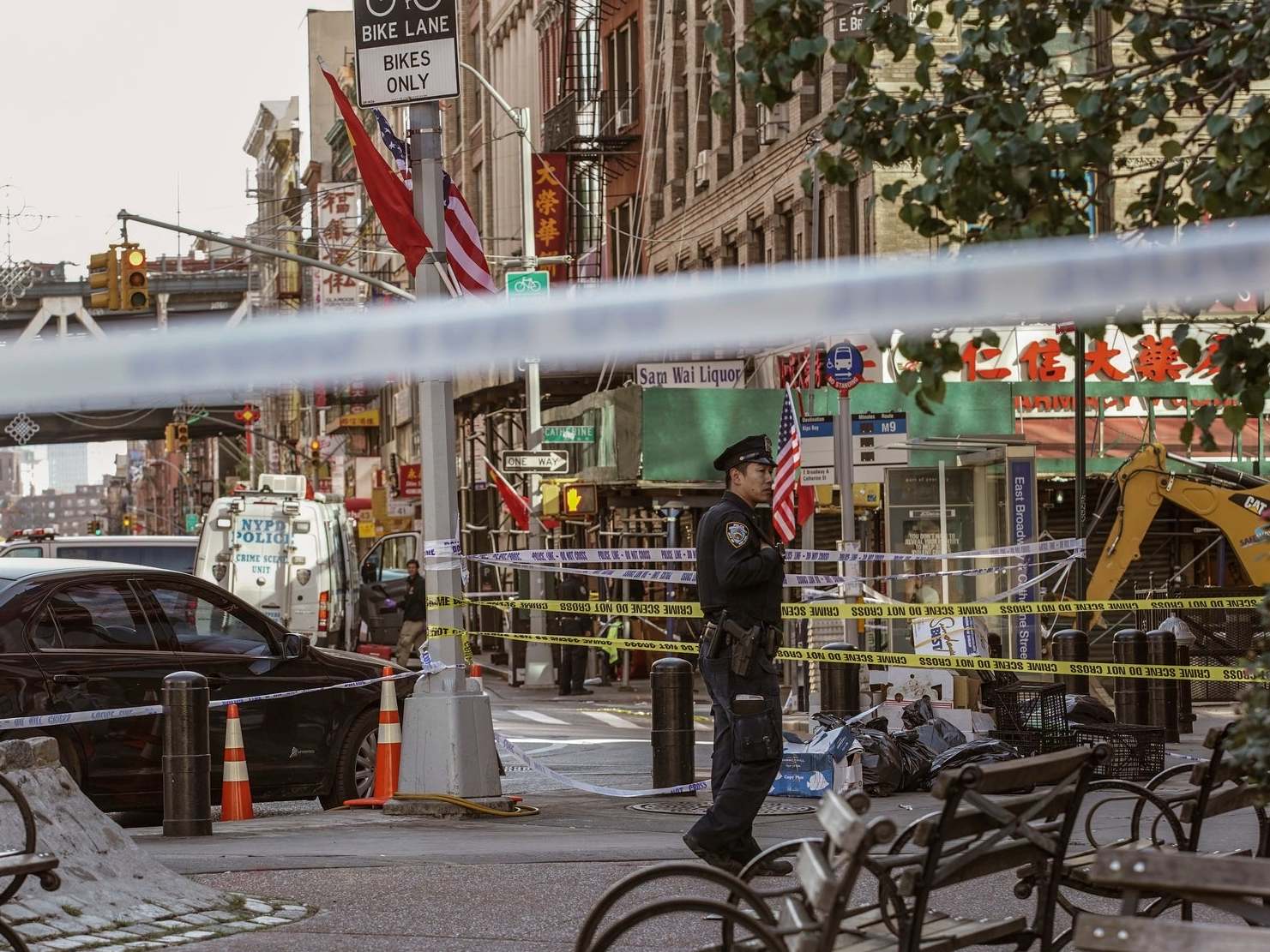 Police officers investigate the scene of one of the attacks in Manhattan's Chinatown neighborhood