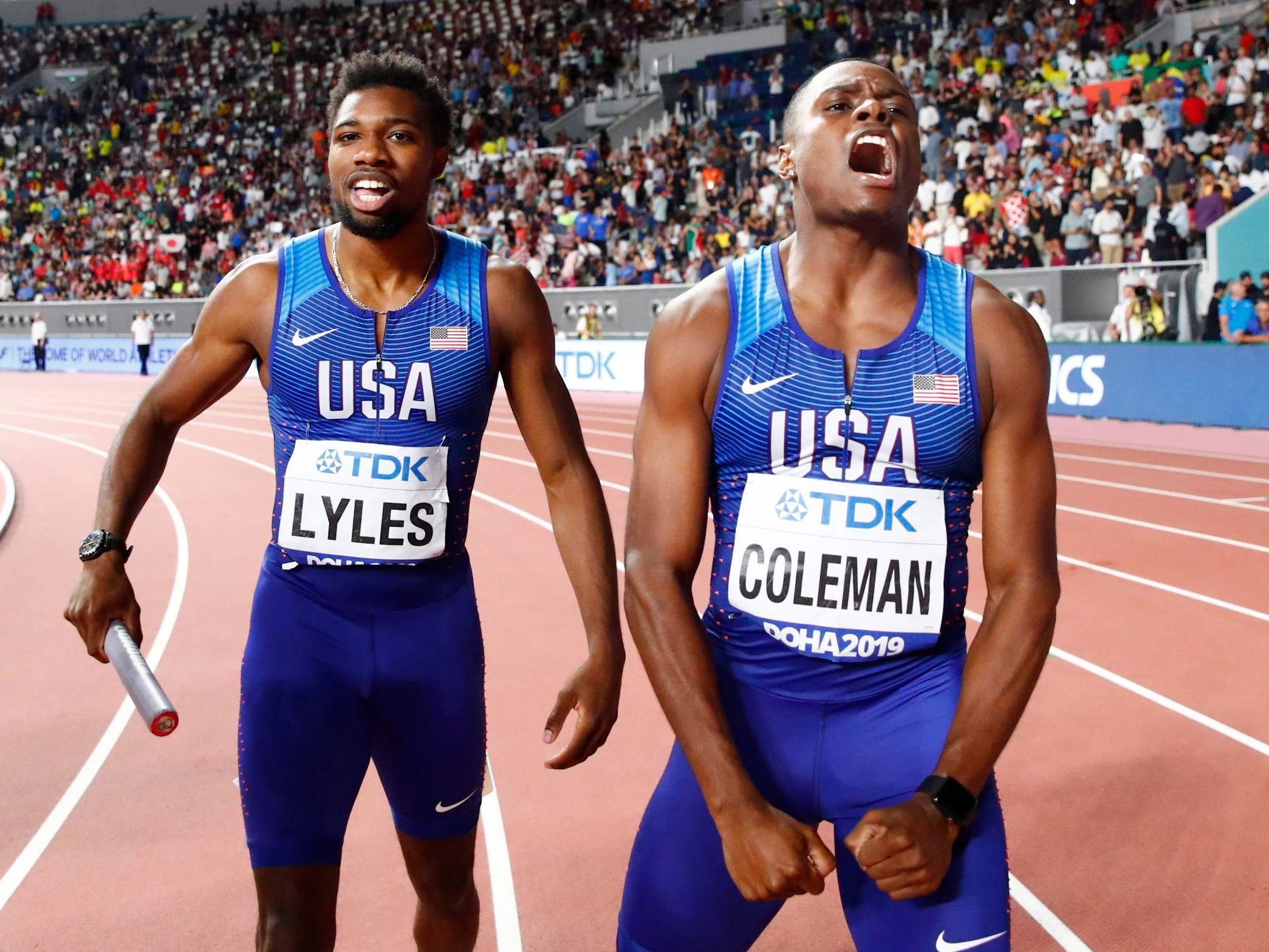 Noah Lyles, left, and Christian Coleman celebrate their gold medal