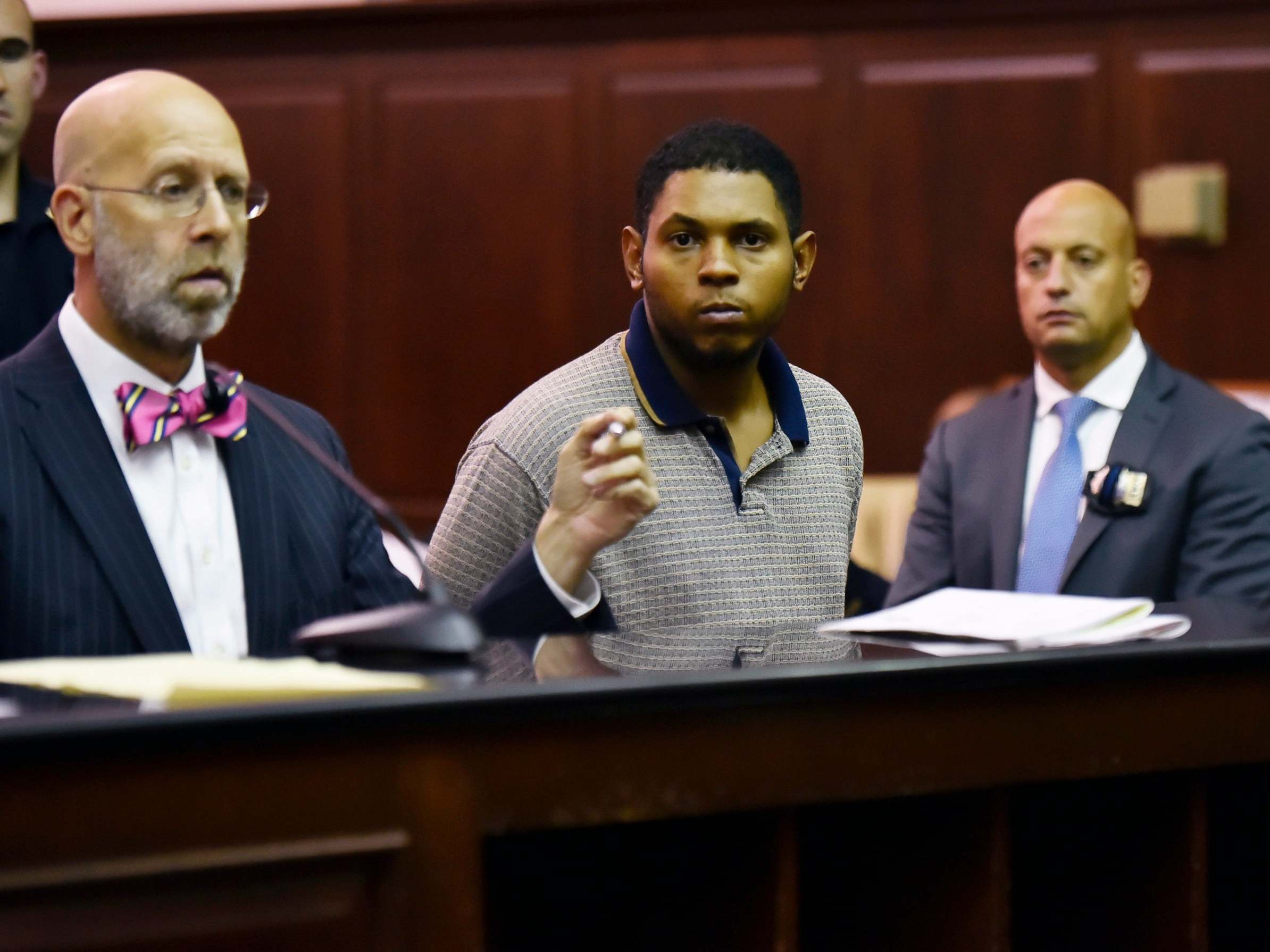 Randy Santos, 24, (centre) appears in court charged with the murder of four homeless men in Manhattan, New York, 6 October 2019.