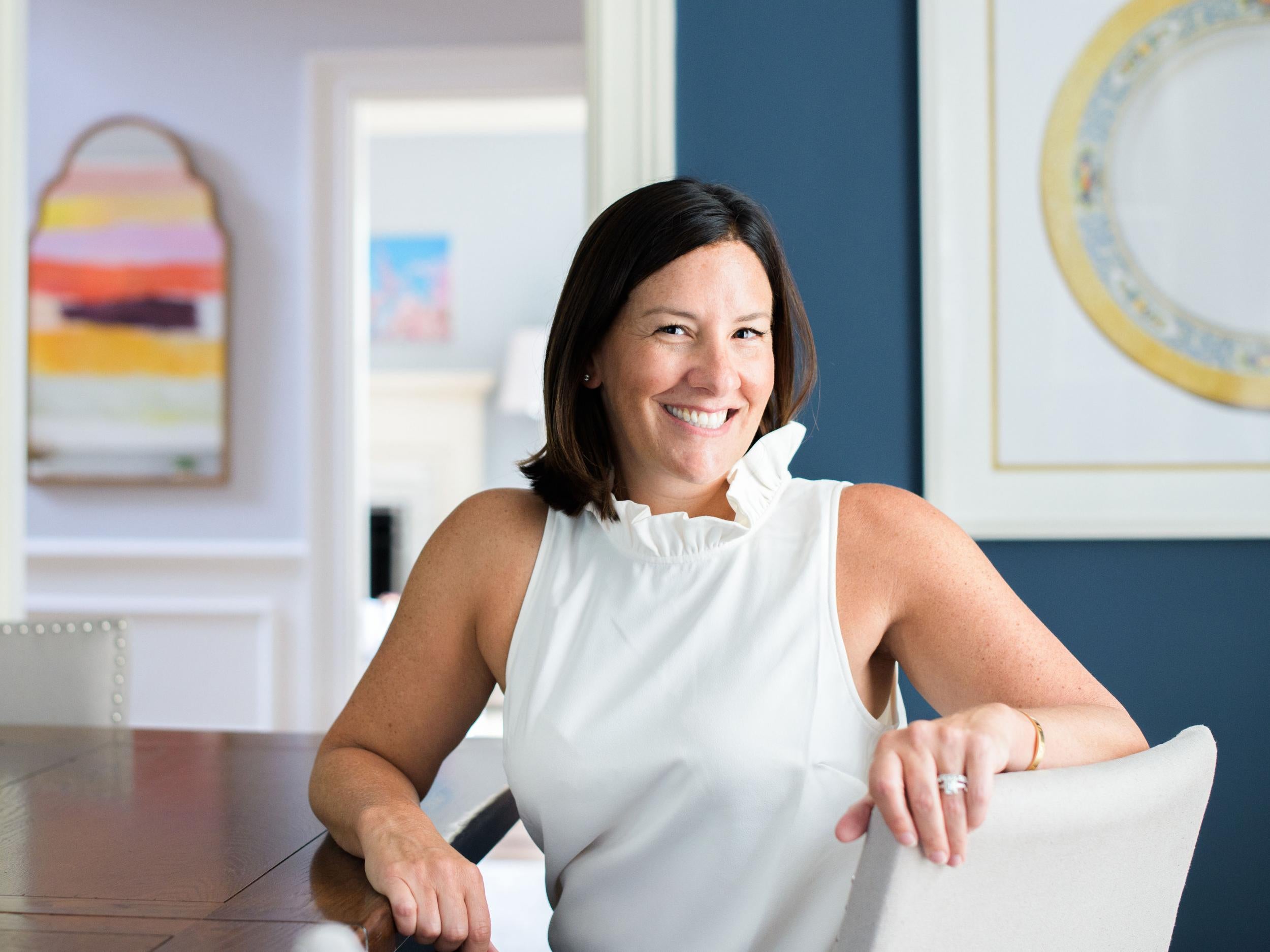 A blown-up photograph of one of her mum’s vintage Lenox plates hangs behind Baum in her Baltimore dining room