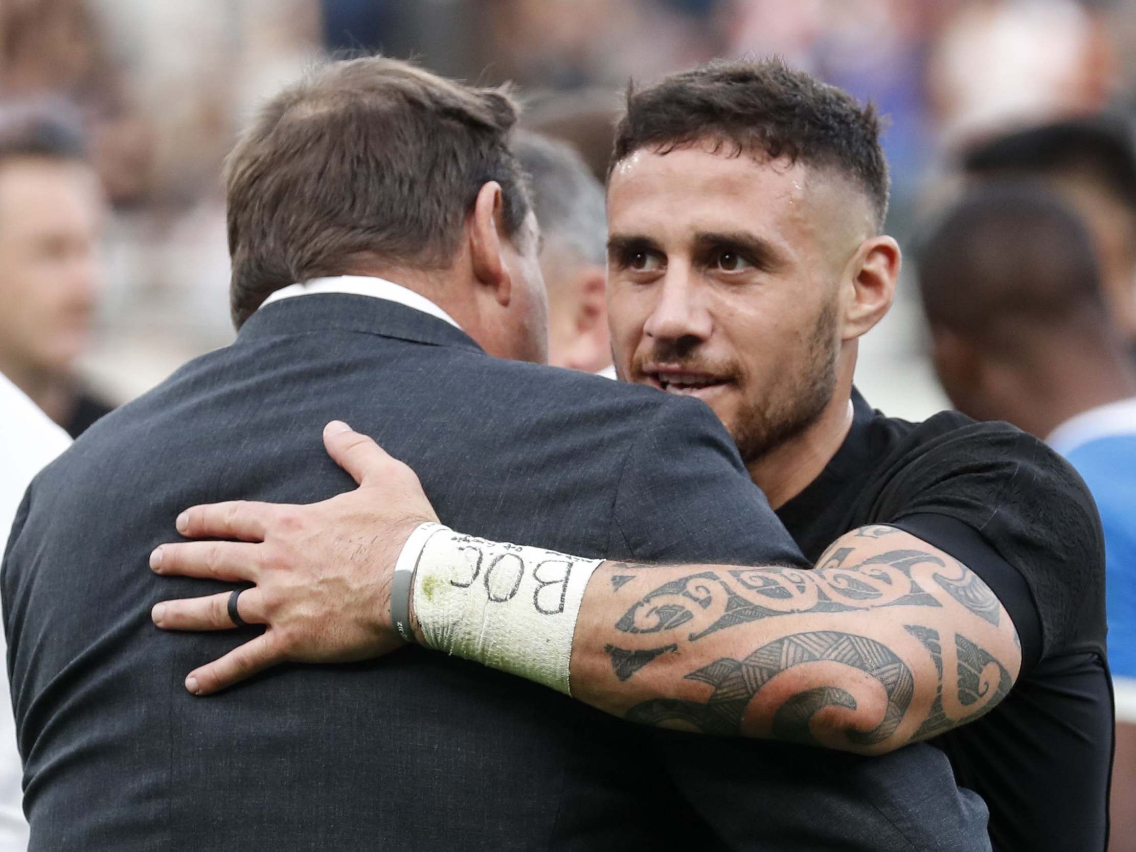 Hansen embraces TJ Perenara after the victory over Namibia