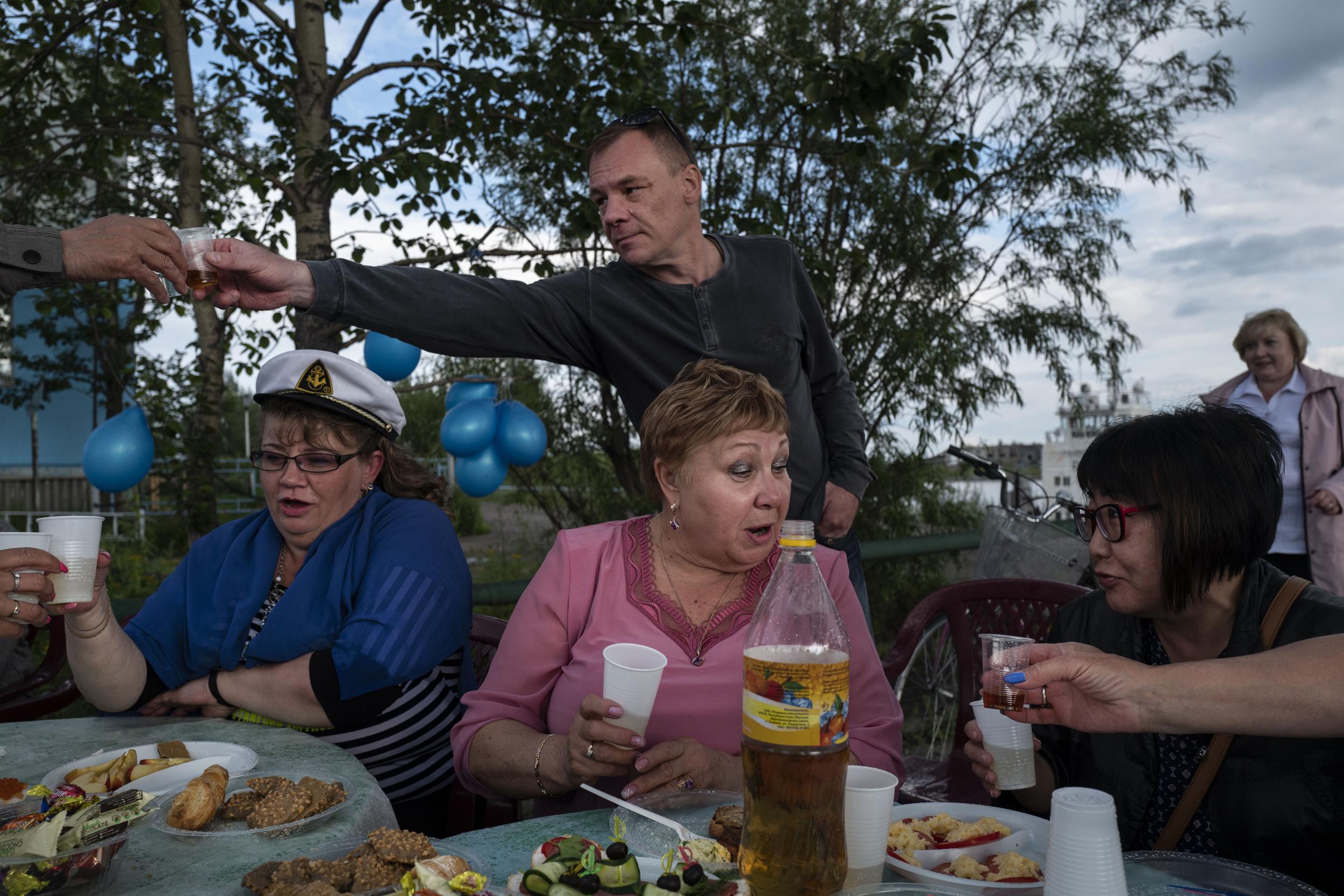 Riverboat workers enjoy a lunch in Zyryanka. Boats are crucial to the area’s economy