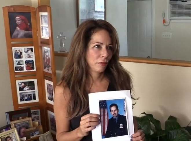 In mourning: Echeverria holds a picture of her brother Robert