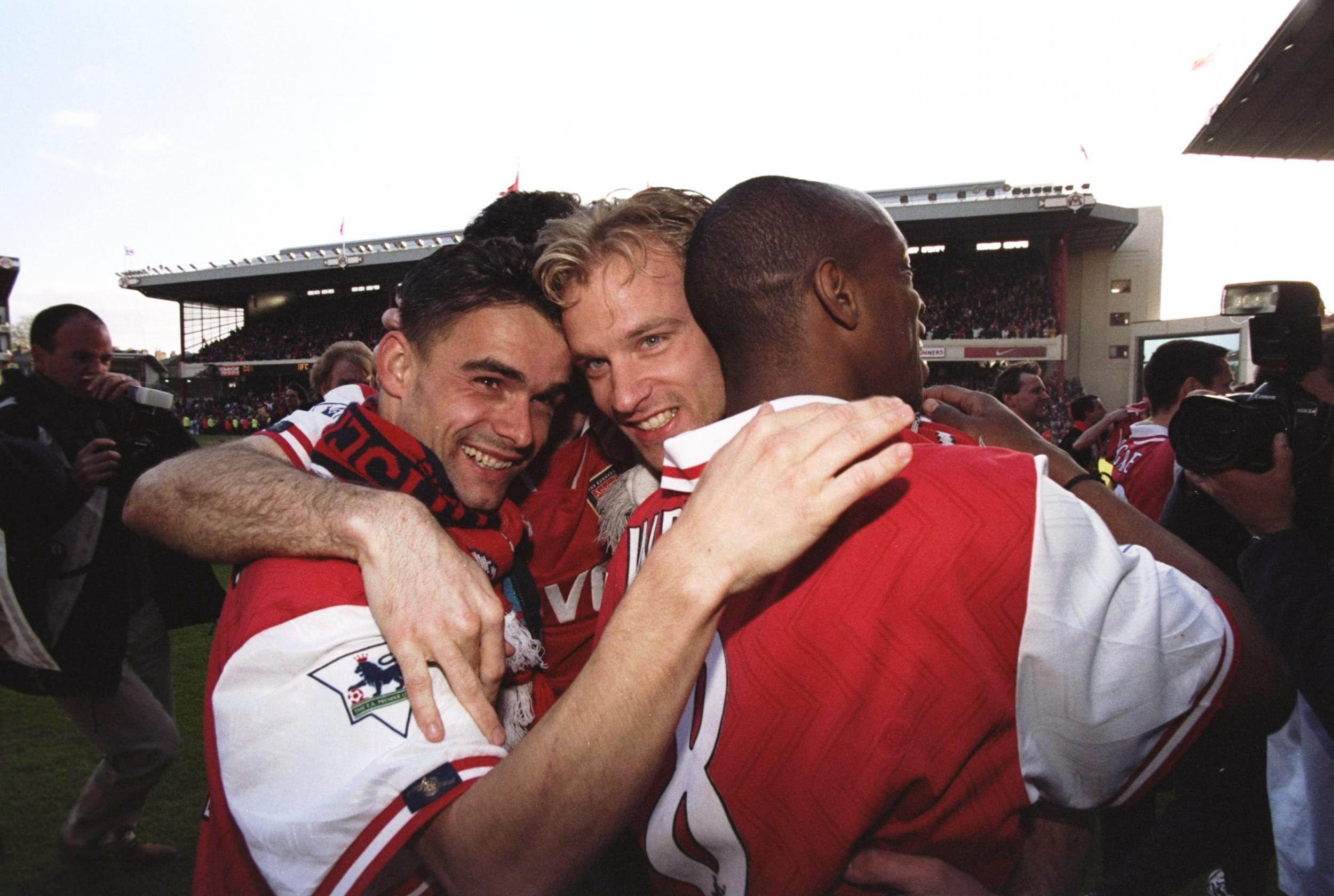 Marc Overmars, Dennis Bergkamp and Ian Wright embrace