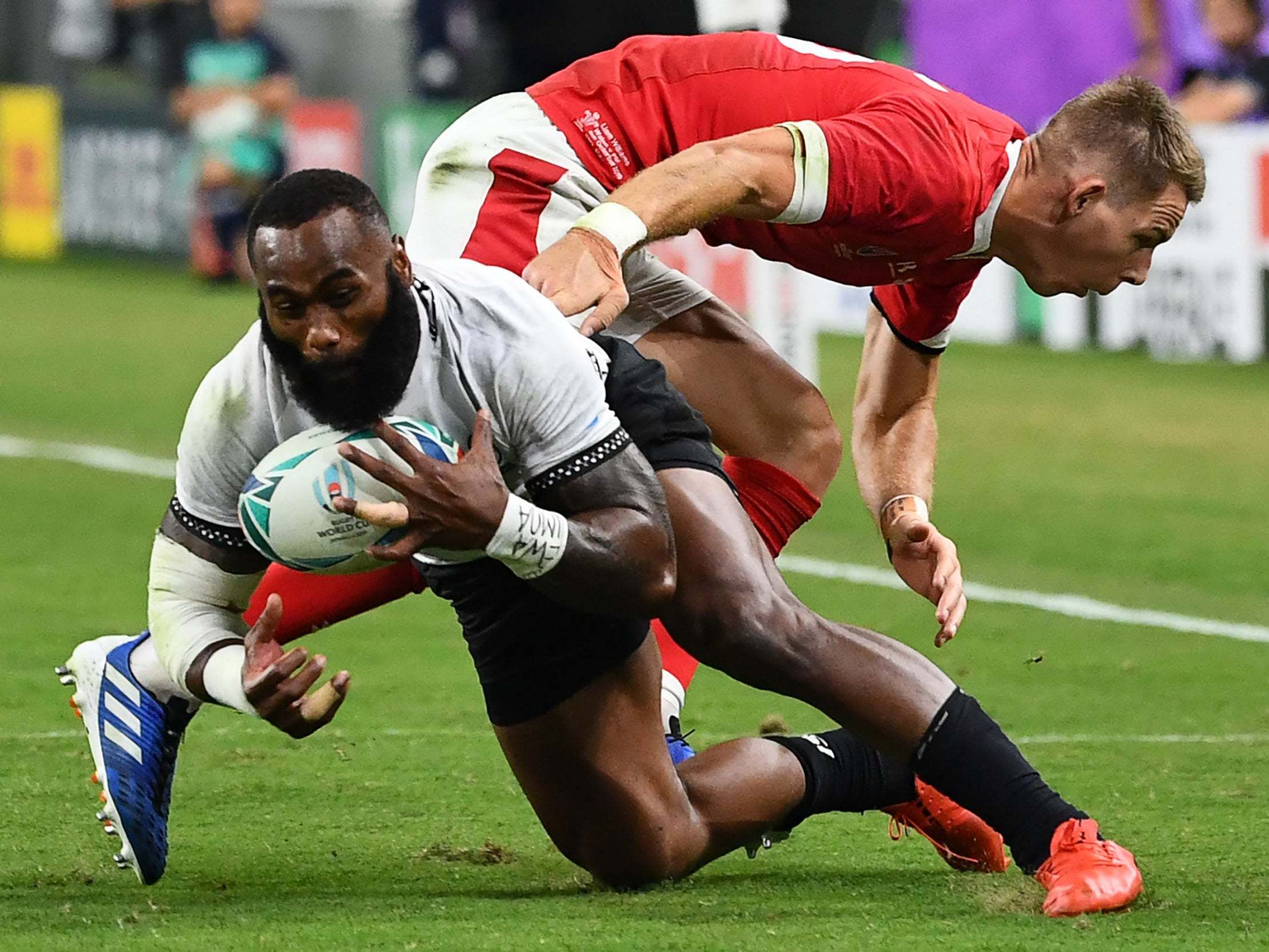 Fiji's Semi Radradra is tackled by Wales' Liam Williams