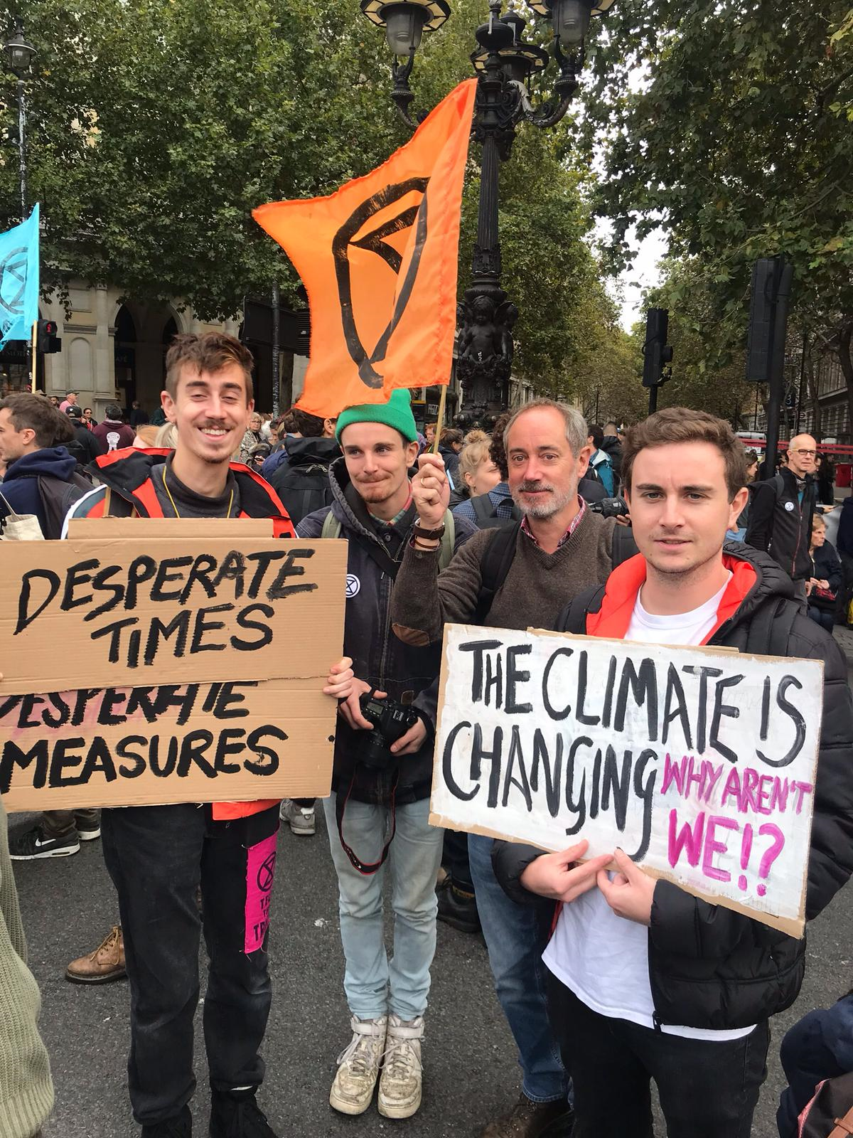 Family affair: Jasper, Archie and Angus Dymoke march with their father, Charles, earlier this week