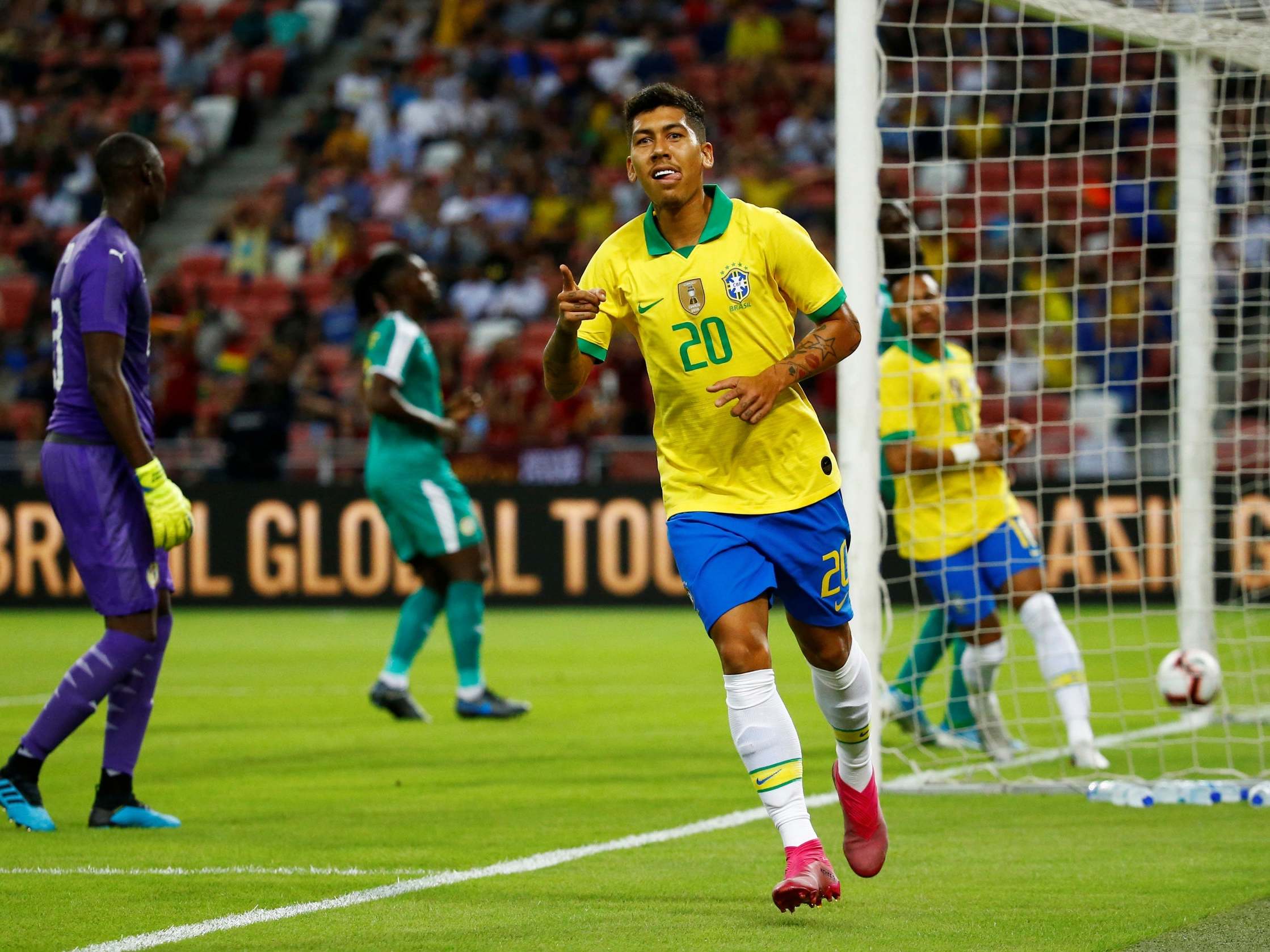 Brazil's Roberto Firmino celebrates scoring their first goal