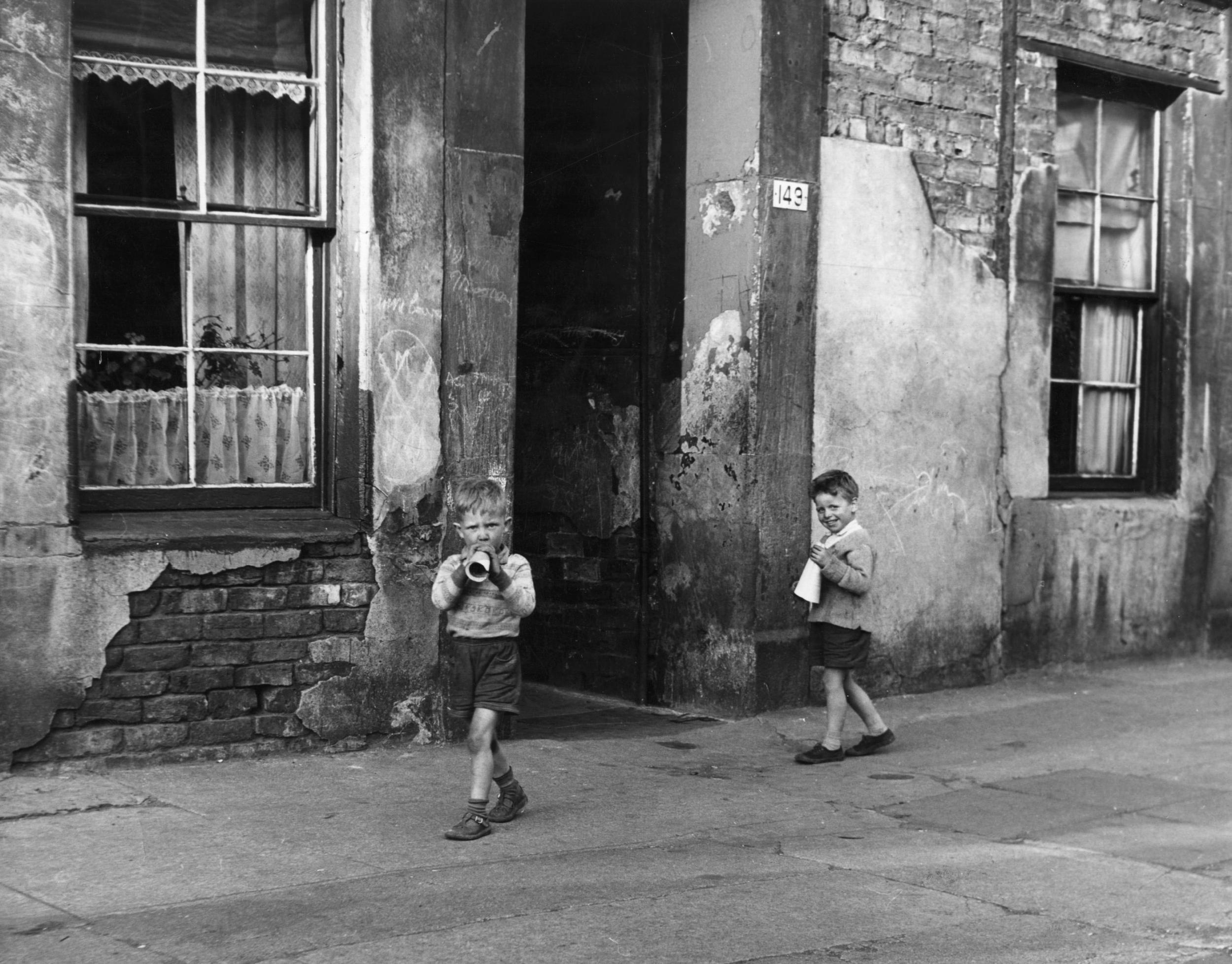 Two young boys playing outside in the Gorbals district of Glasgow