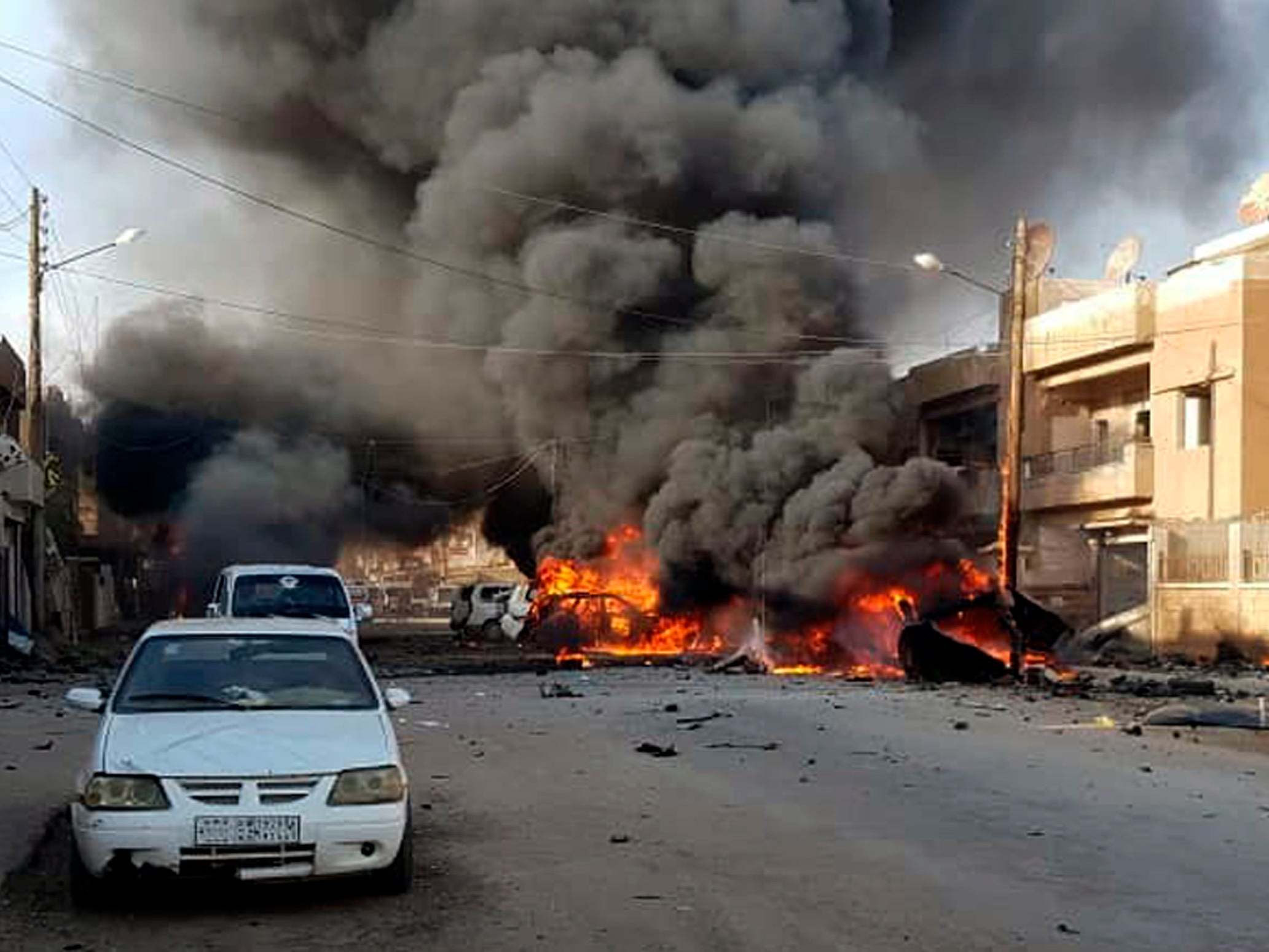 Flames rise from burnt cars in the north of the country