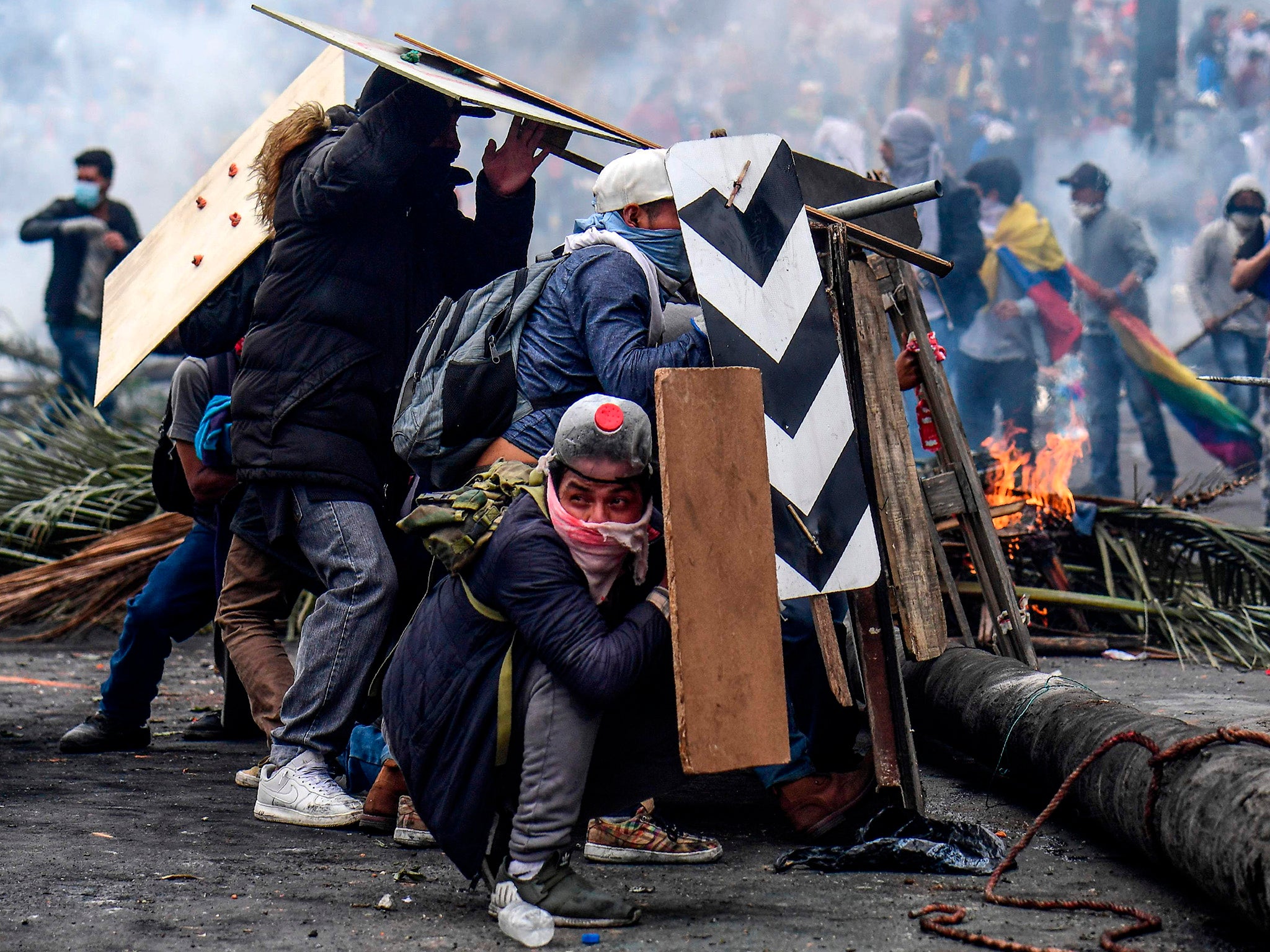 Advancing protesters are met with tear gas fired by riot police (AFP/Getty)