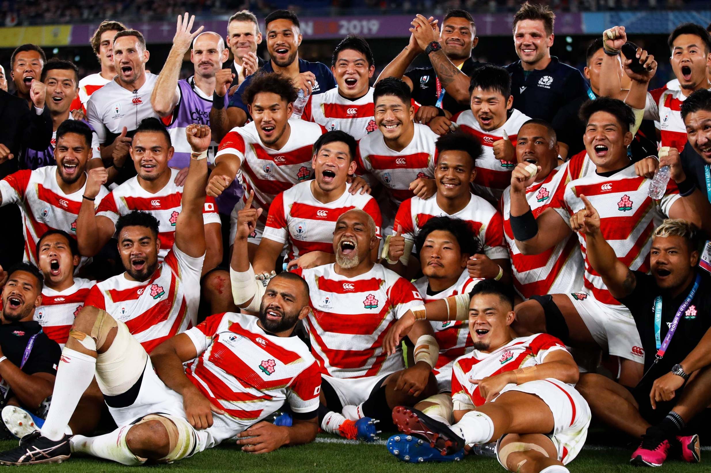 Japan celebrate their historic victory over Scotland (AFP via Getty)