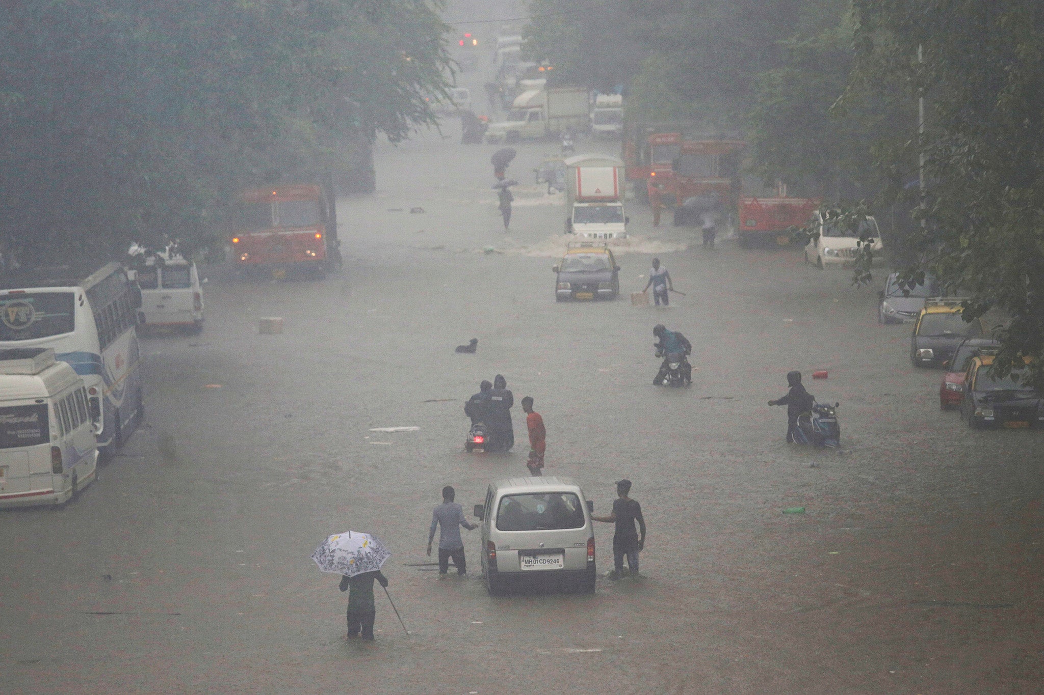 Commuters navigating a flooded street in Mumbai after heavy rainfall in September