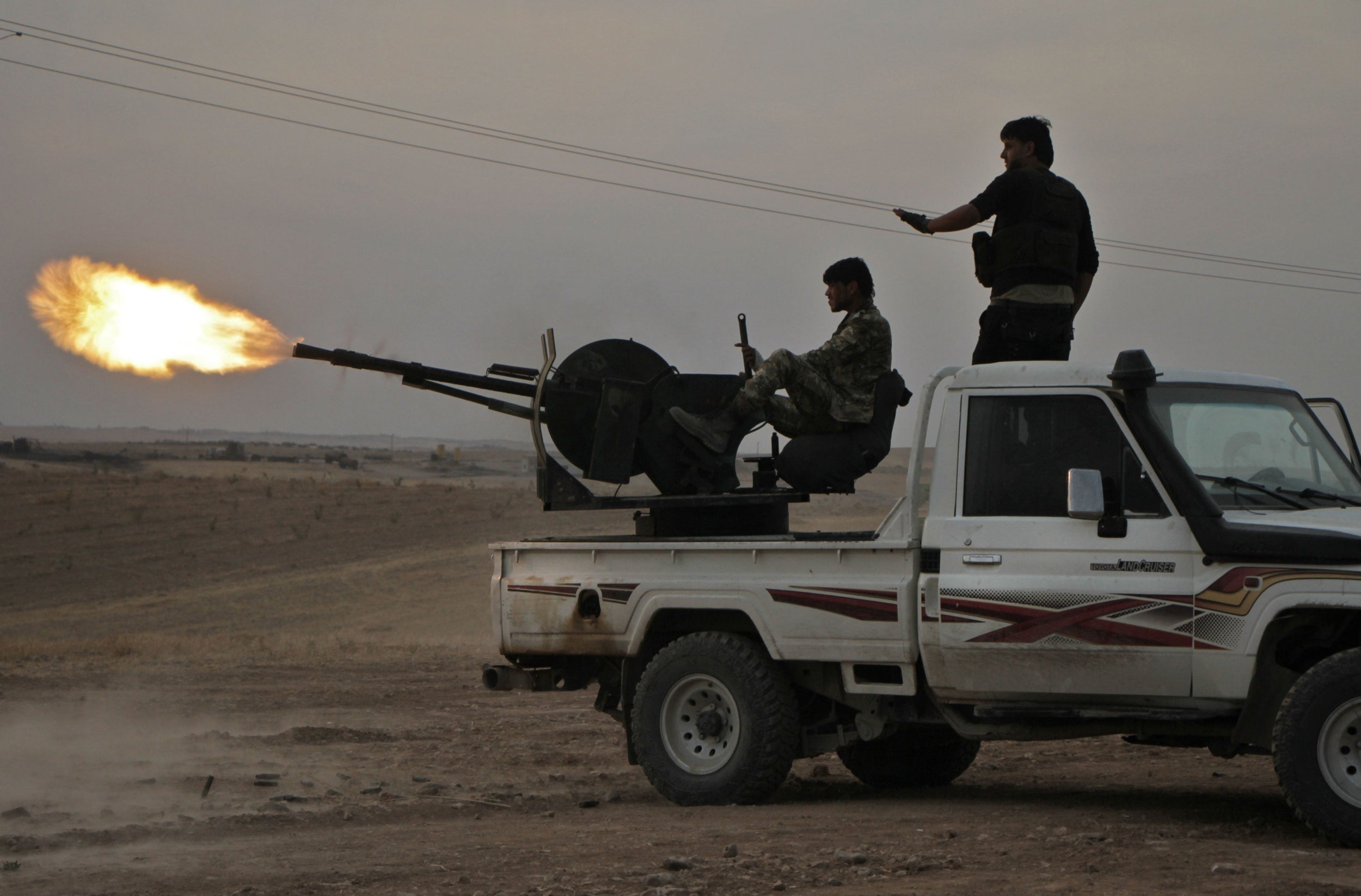 Turkish-backed Syrian fighters fire from a near the town of Tukhar on Monday (AFP/Getty)