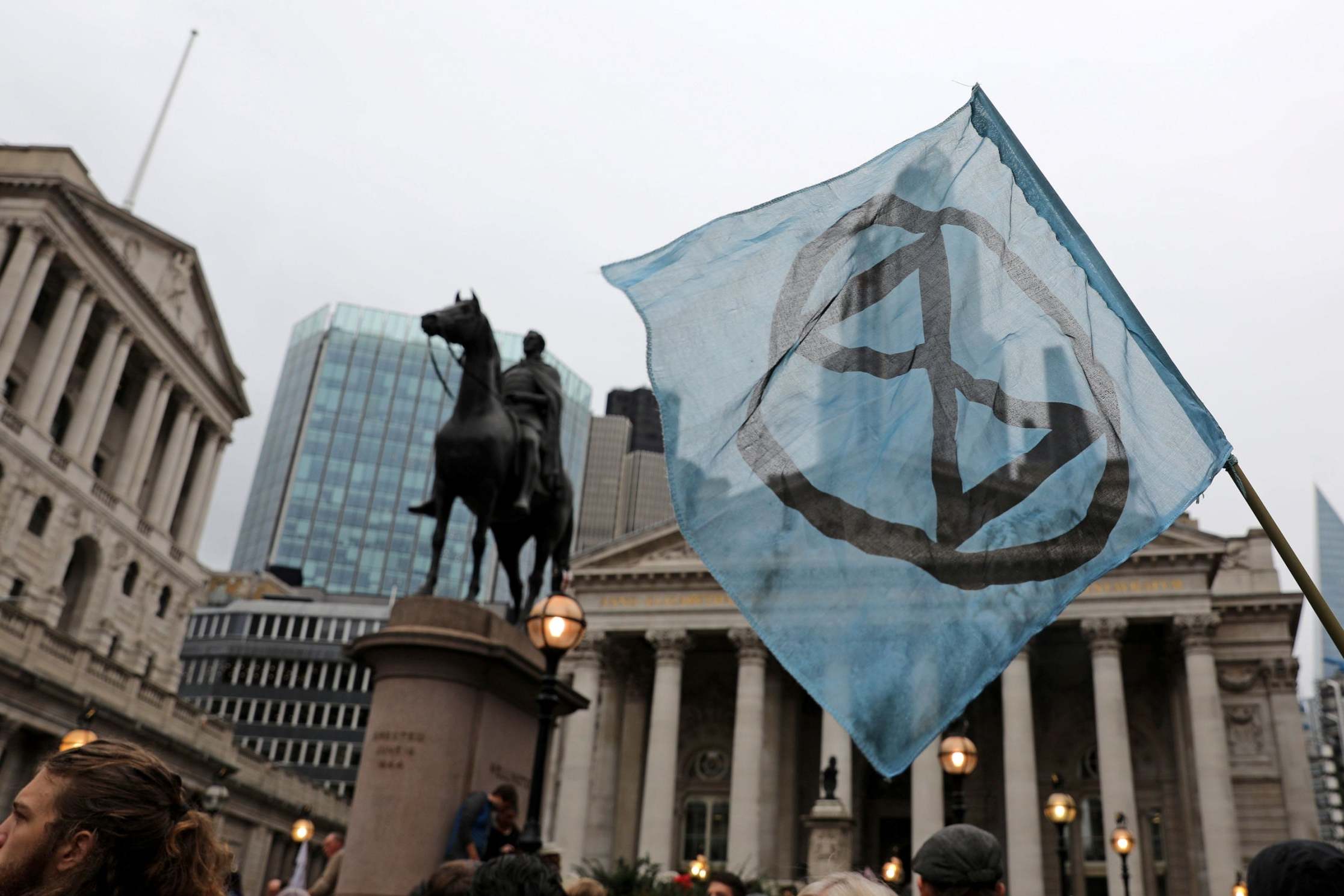 Activists hold placards as they protest outside the Bank of England