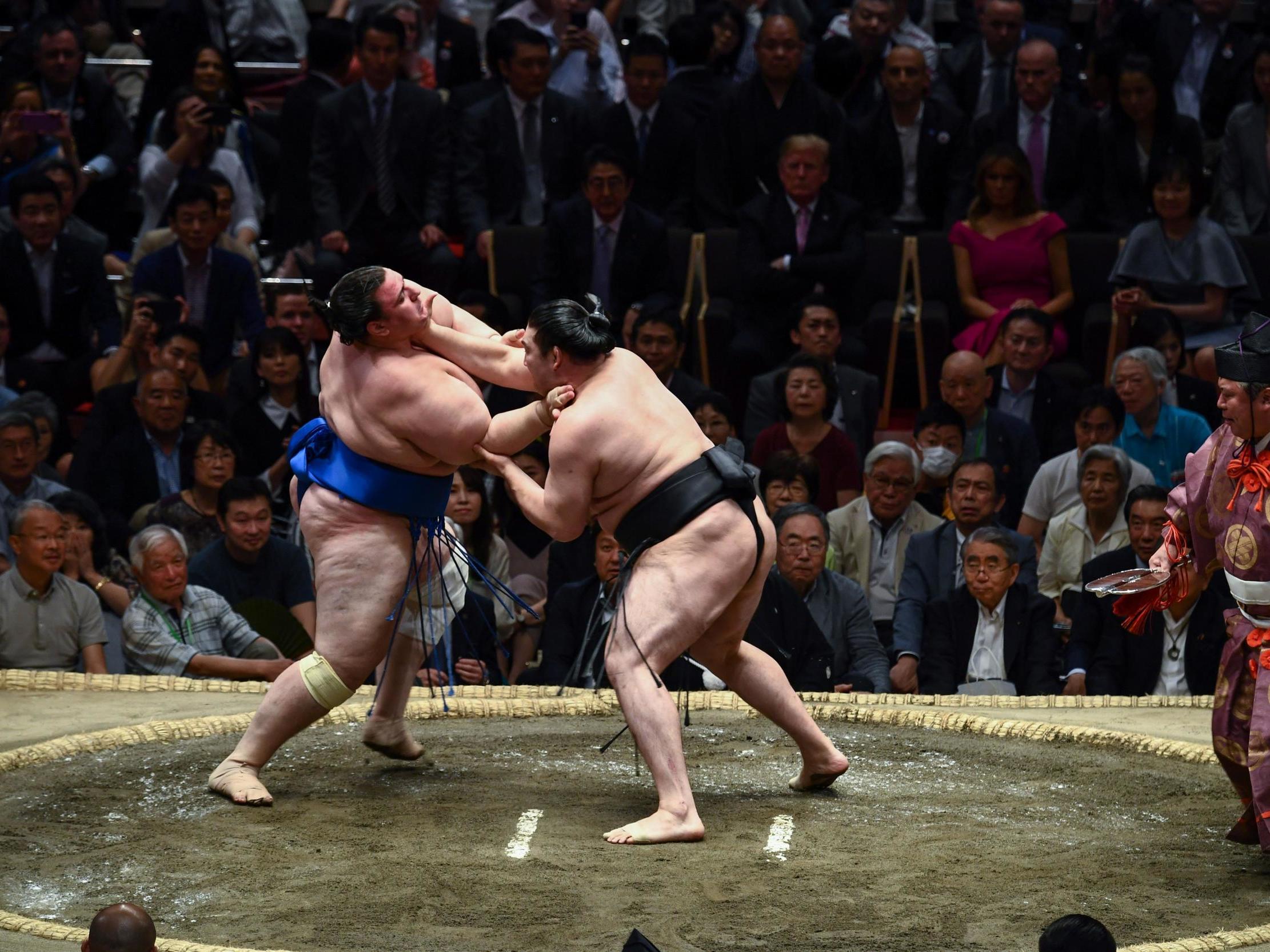 Japan’s Ryuden attempts to grab the throat of Aoiyama of Bulgaria during their clash