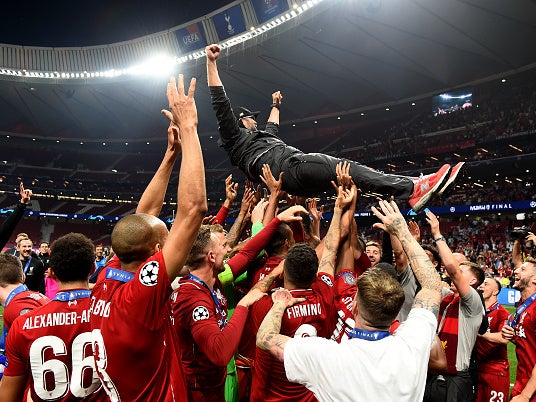 Liverpool’s players lift Jurgen Klopp into the air after winning the Champions League final