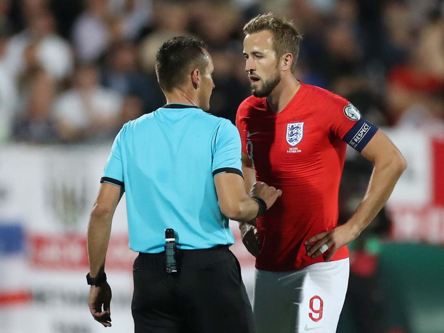 Harry Kane speaks to the referee about racist abuse during the match