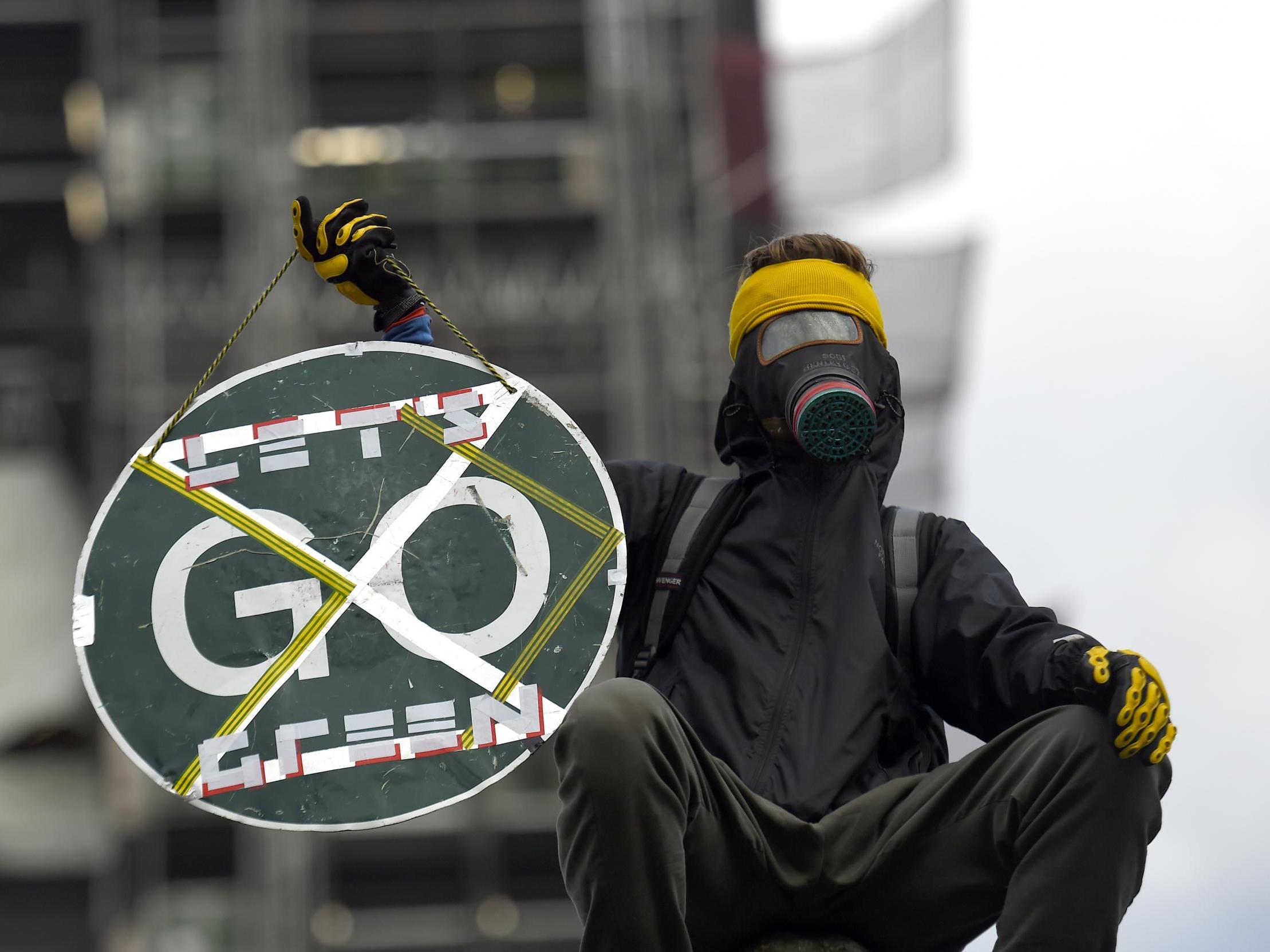 A protester scales the walls of parliament