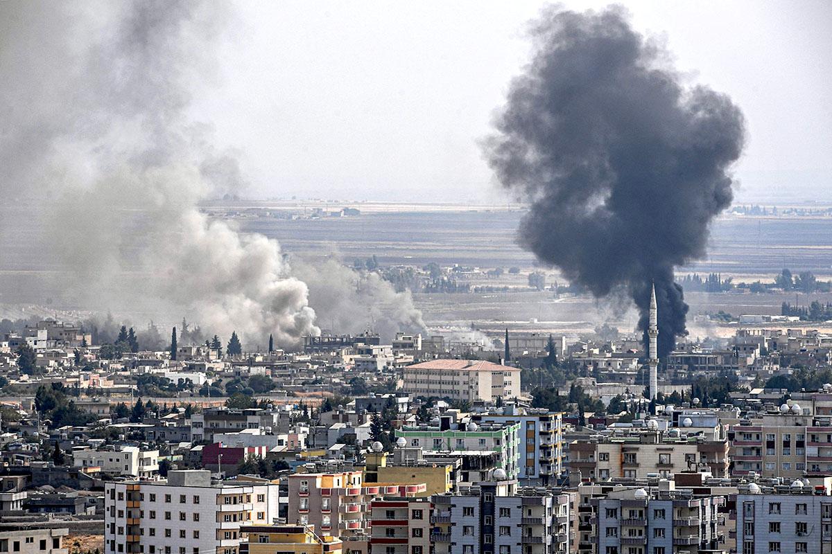 Smoke rises from the Syrian town of Ras al-Ayn after an attack on Wednesday