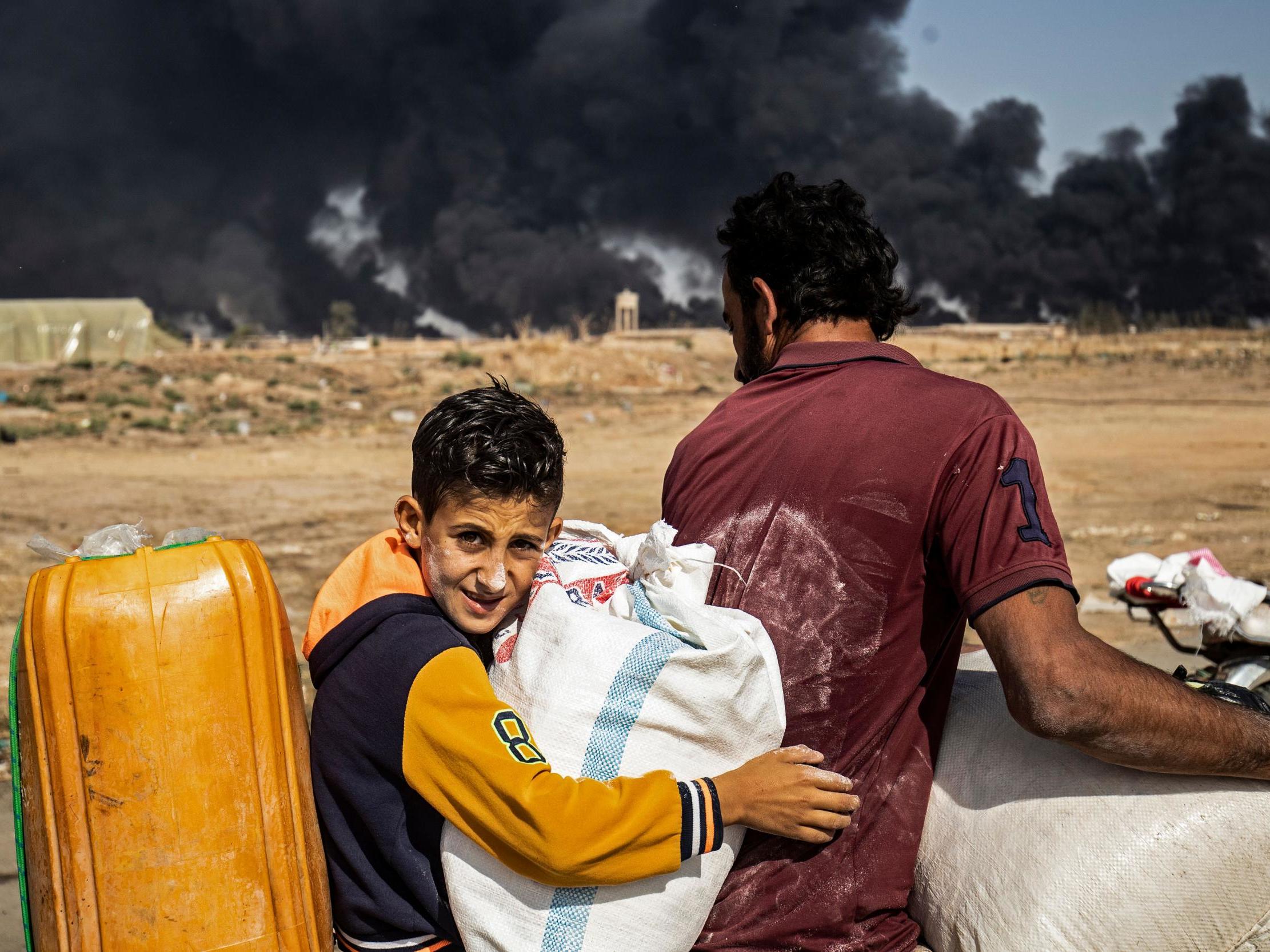 Displaced people, fleeing from the countryside of the Syrian Kurdish town of Ras al-Ain along the border with Turkey.