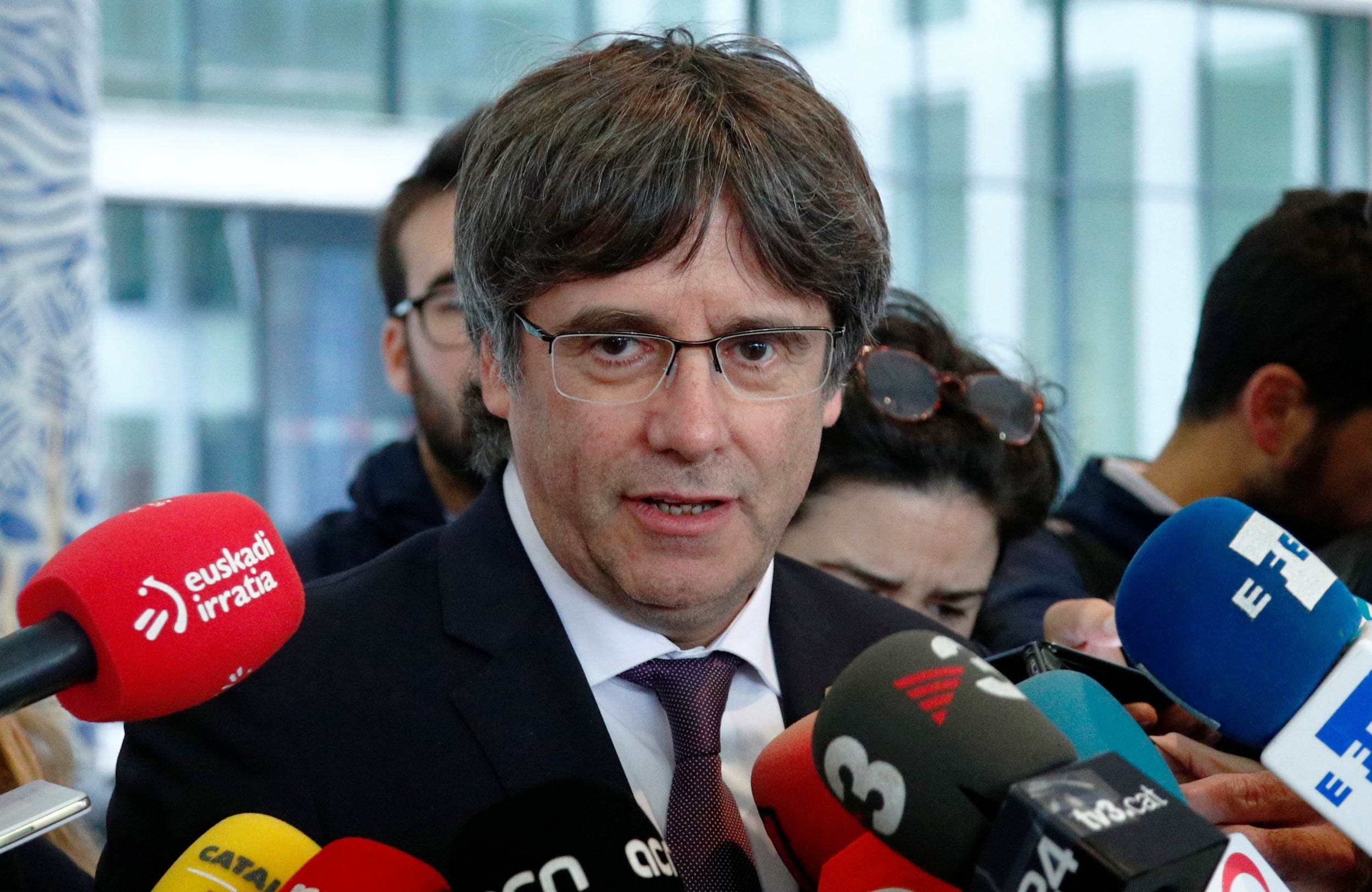 Carles Puigdemont leaves a prosecutor office at the Justice Palace after handing himself in to police in Brussels