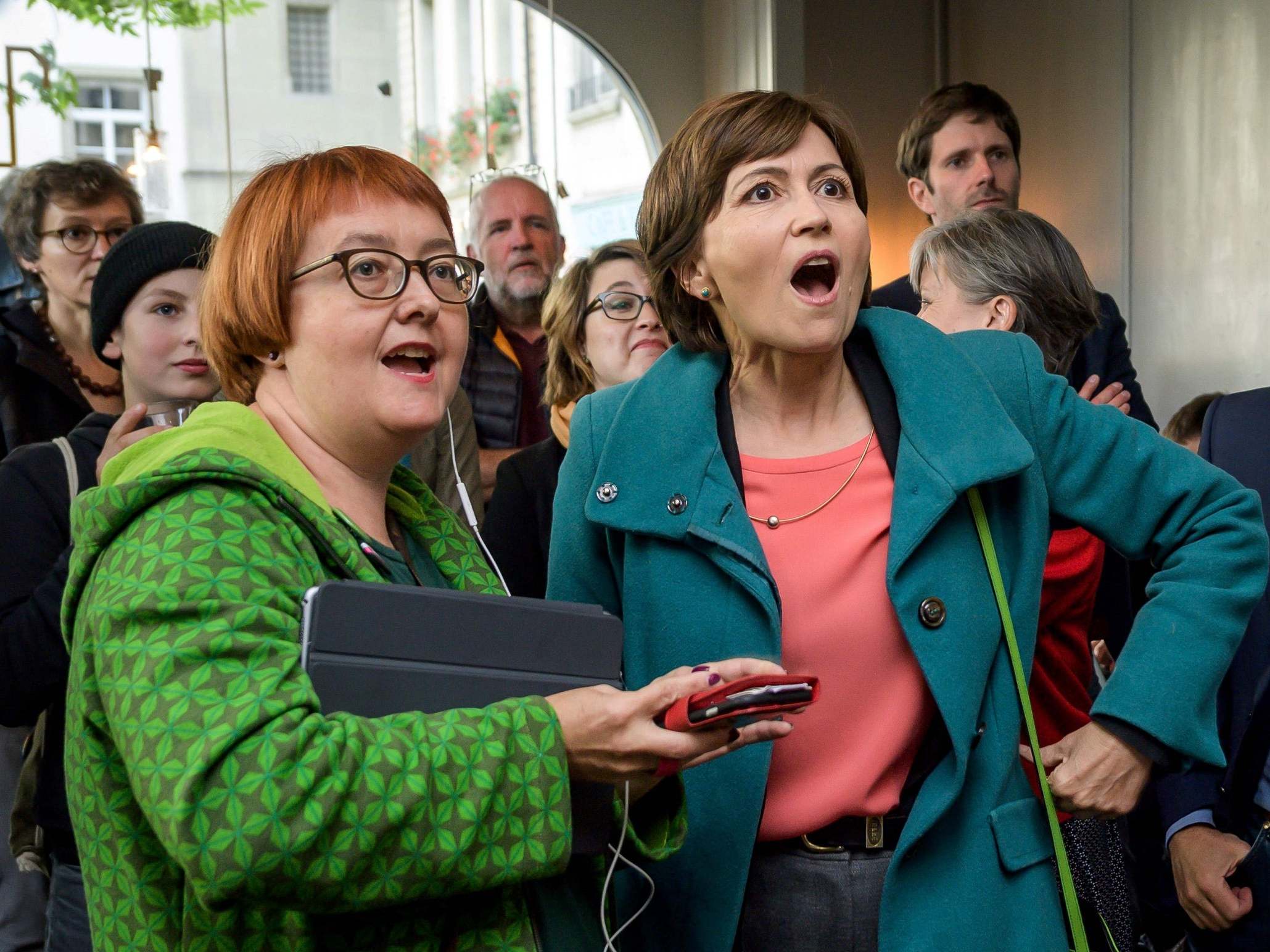 Green Party leader Regula Rytz (right) takes in the announcement of the first election results in Bern