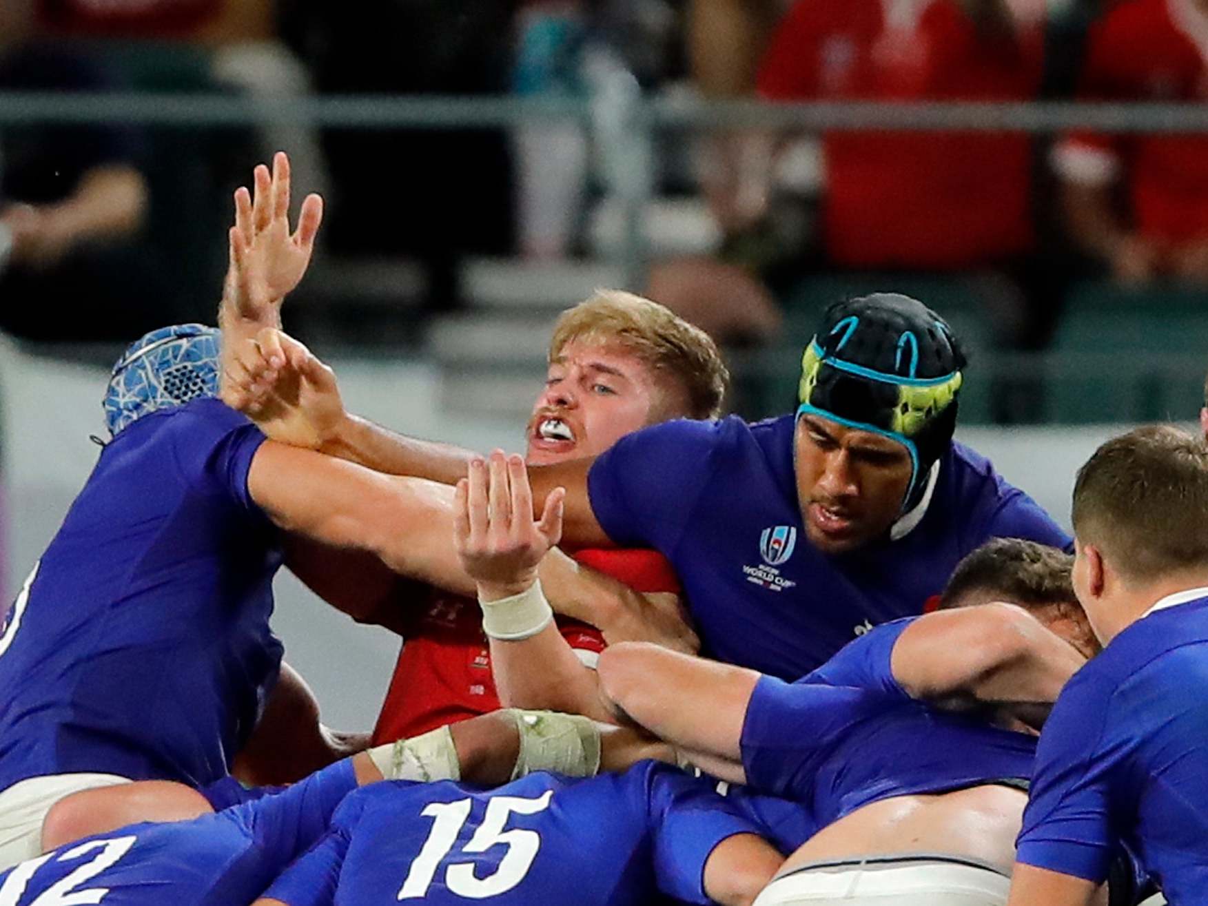 France's Sebastien Vahaamahina, center, elbows Wales' Aaron Wainwright