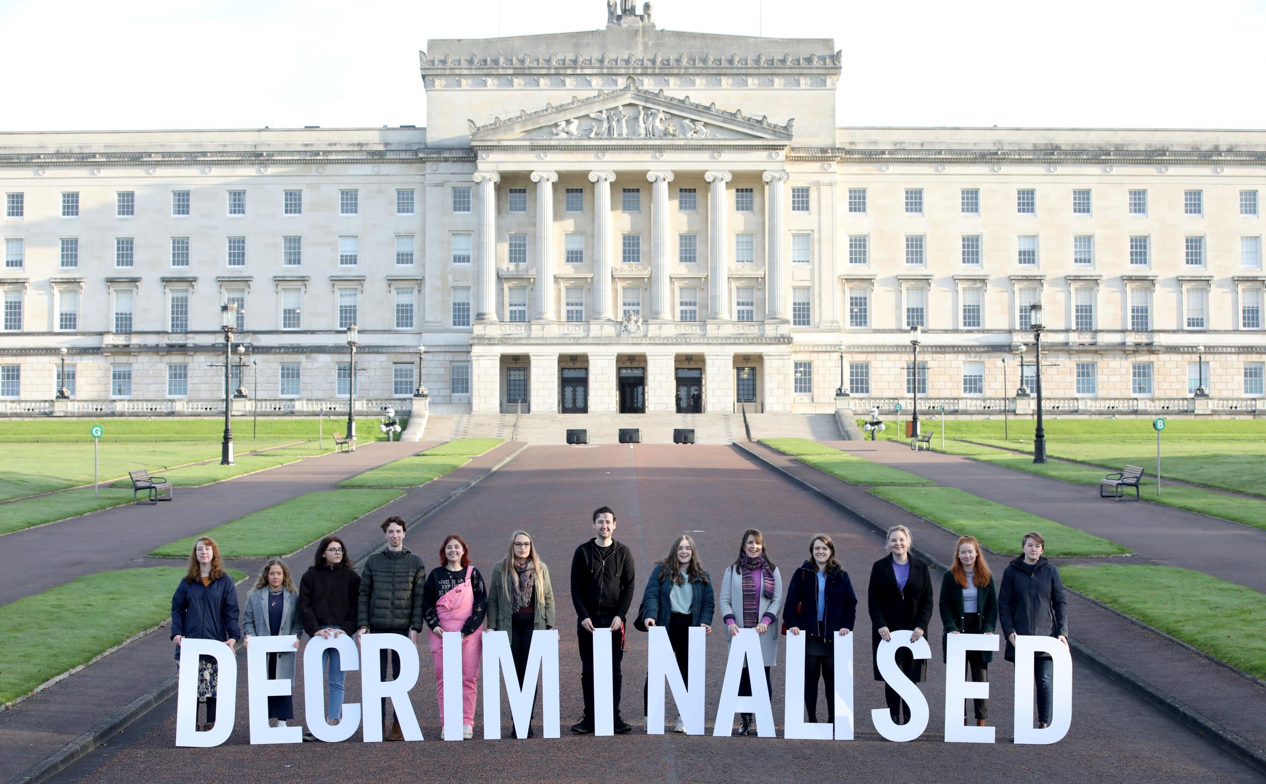 Pro-choice campaigners stood outside the Stormont Estate on Monday 21 October with the word "decriminalised" spelt out in front of them as some of Stormont’s assembly members returned to the chamber for the first time in nearly three years. A group of Northern Irish lawmakers returned to parliament in a failed last-minute protest at the decriminalisation of abortion in the region.