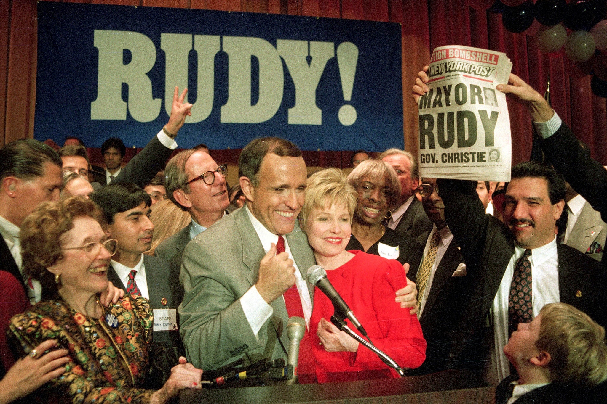 Mr Giuliani celebrates with supporters and wife Donna after winning the New York mayoral race in 1993