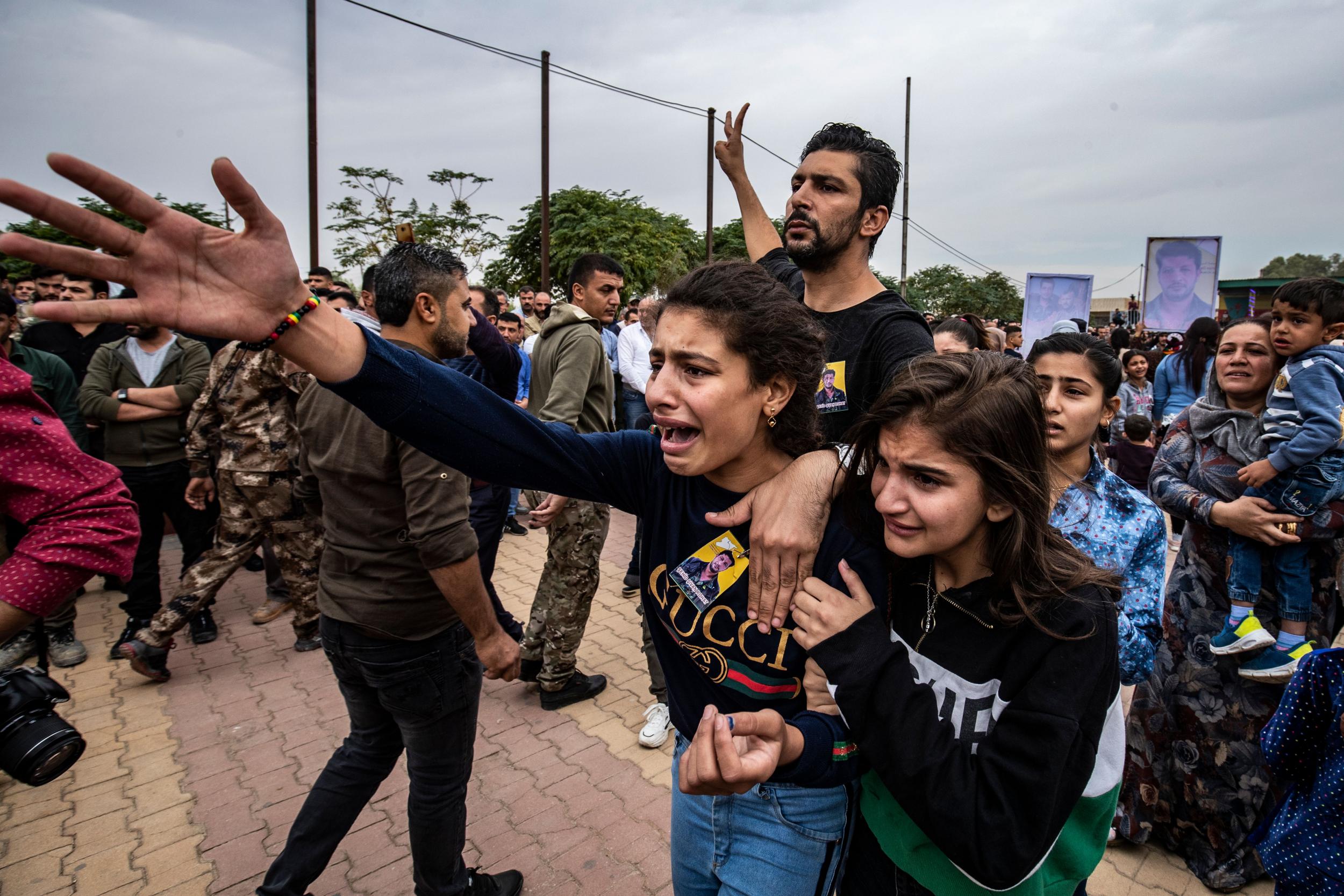 Mourners attend the funeral of three Kurdish fighters killed in battles against Turkish-led forces in the flashpoint town of Ras al-Ayn