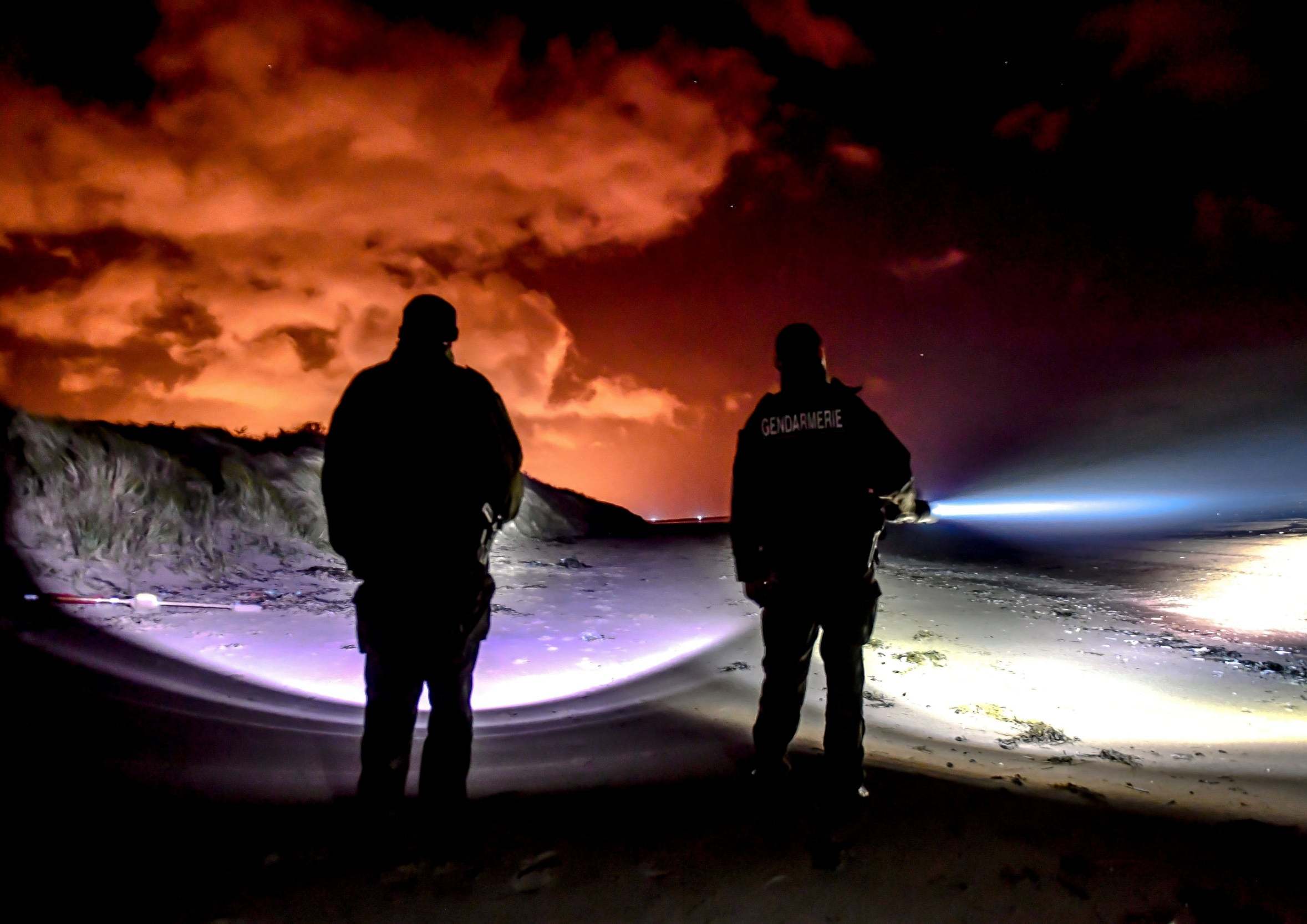 Gendarmes patrol on the beach of Oye-Plage, near Calais, as they try to intercept migrants attempting to cross the Channel