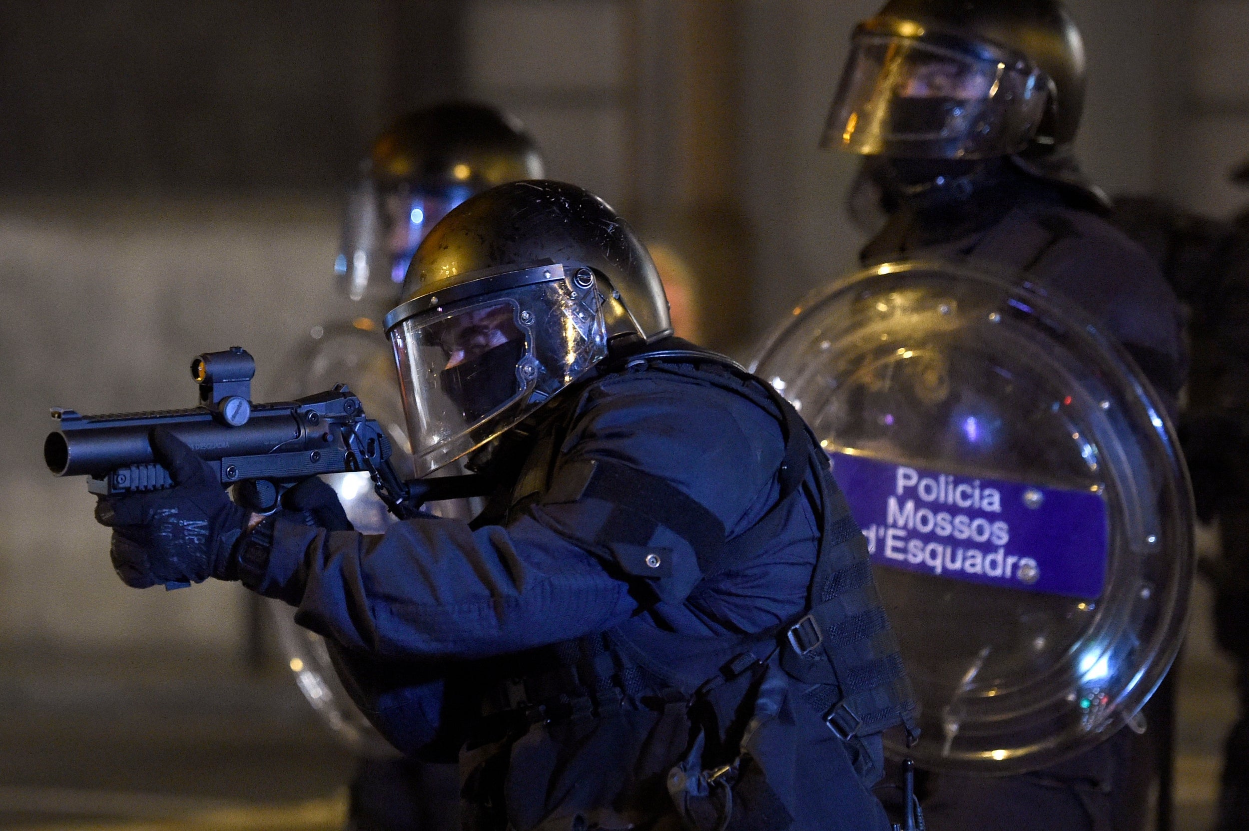 Police officer shoots his gun against pro-independence protesters,