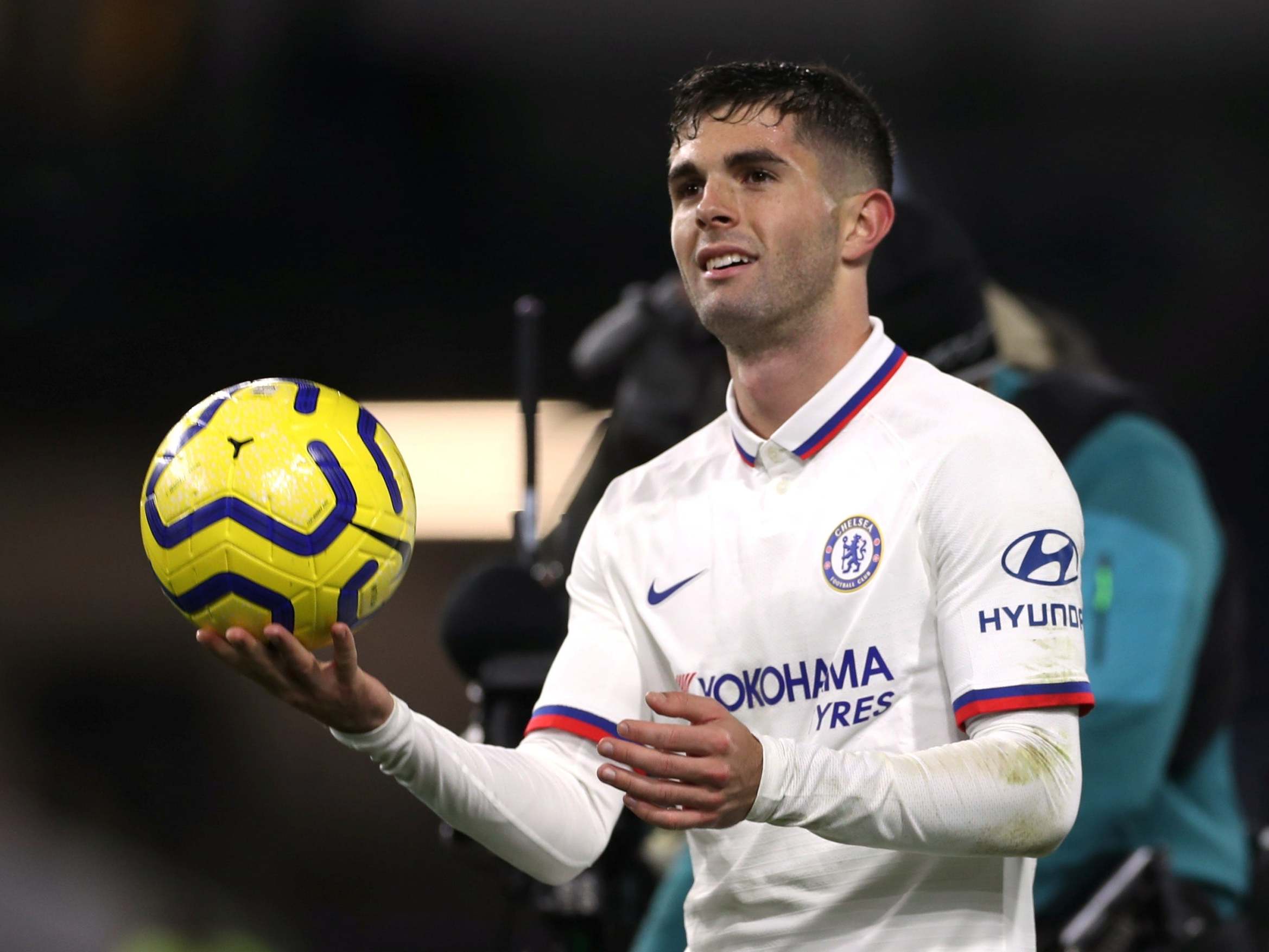 Christian Pulisic celebrates with the match ball