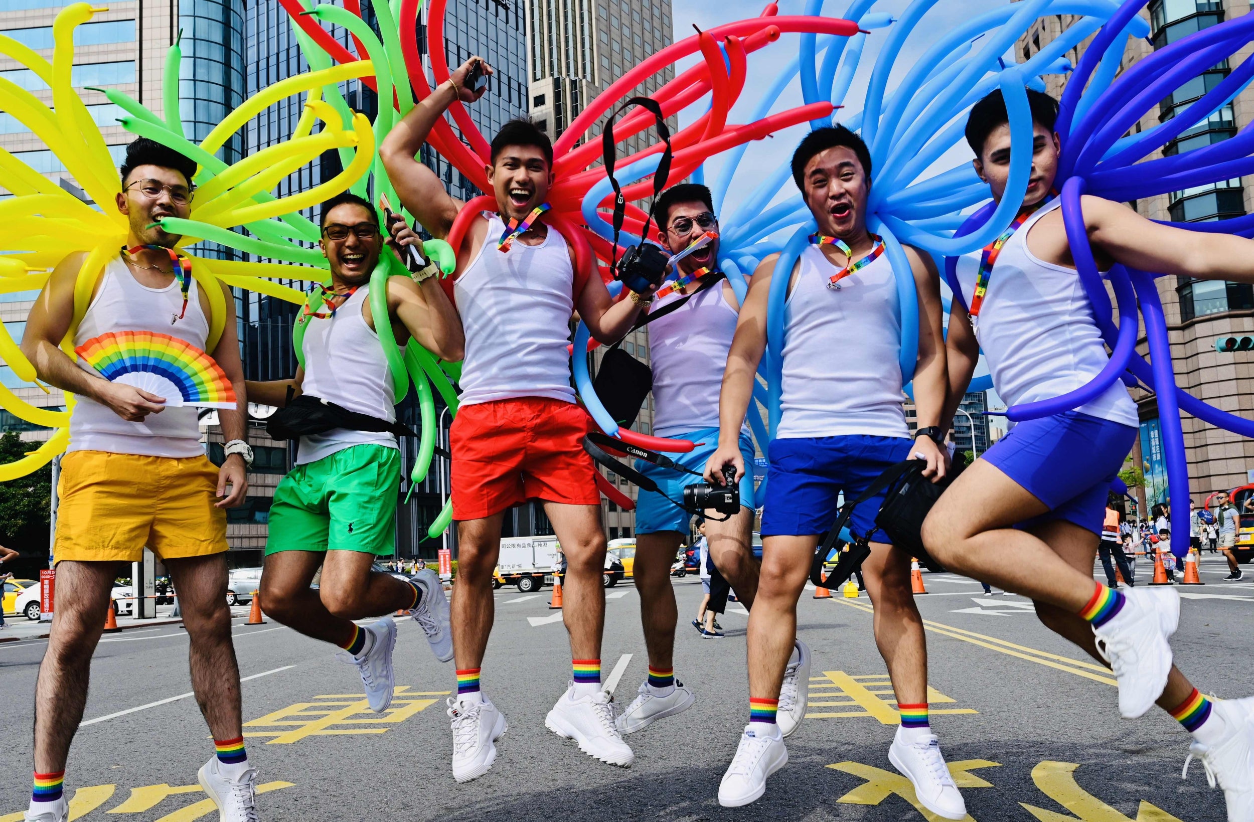 Participants jump during the annual pride parade in Taipei. It is the first to be held since same-sex marriage became legalised