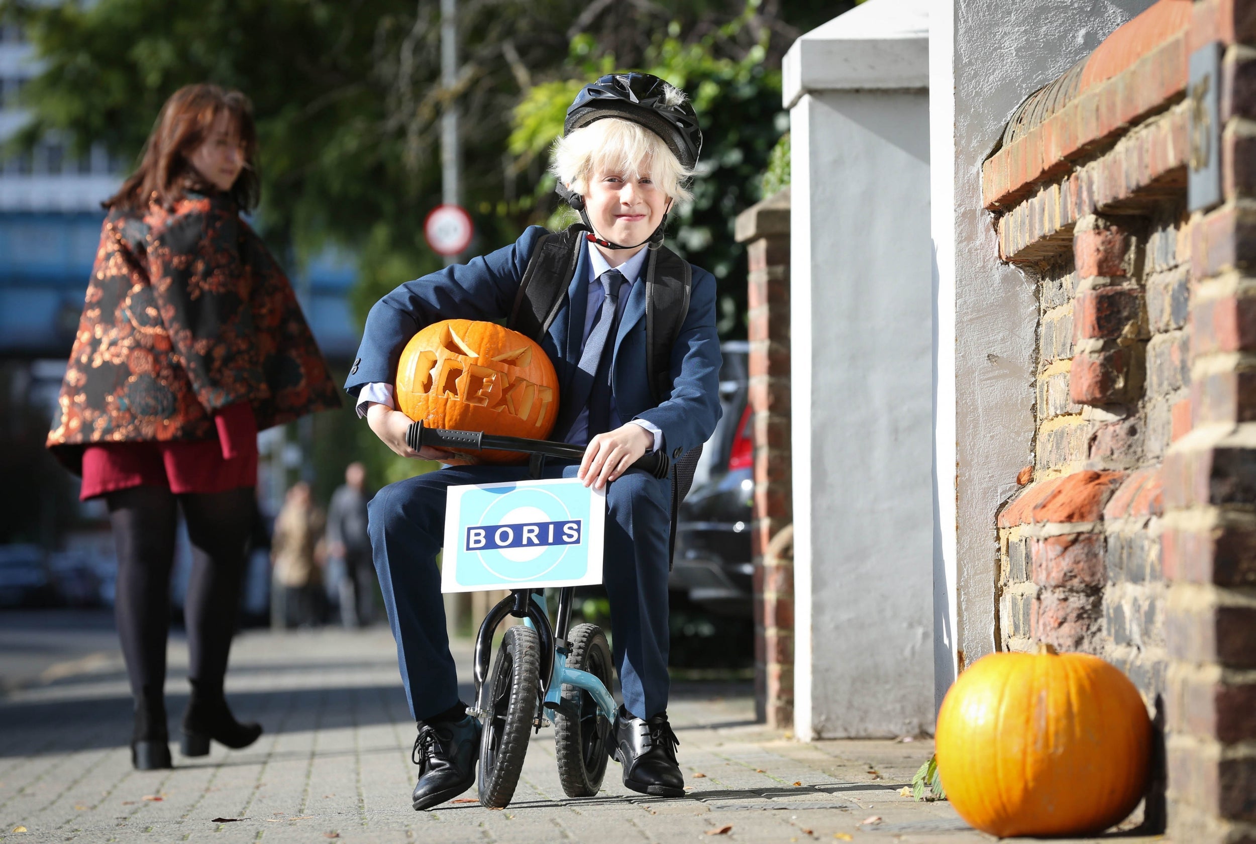 10-year-old Presley Kempson rides a Boris Bike dressed as the prime minister for Halloween