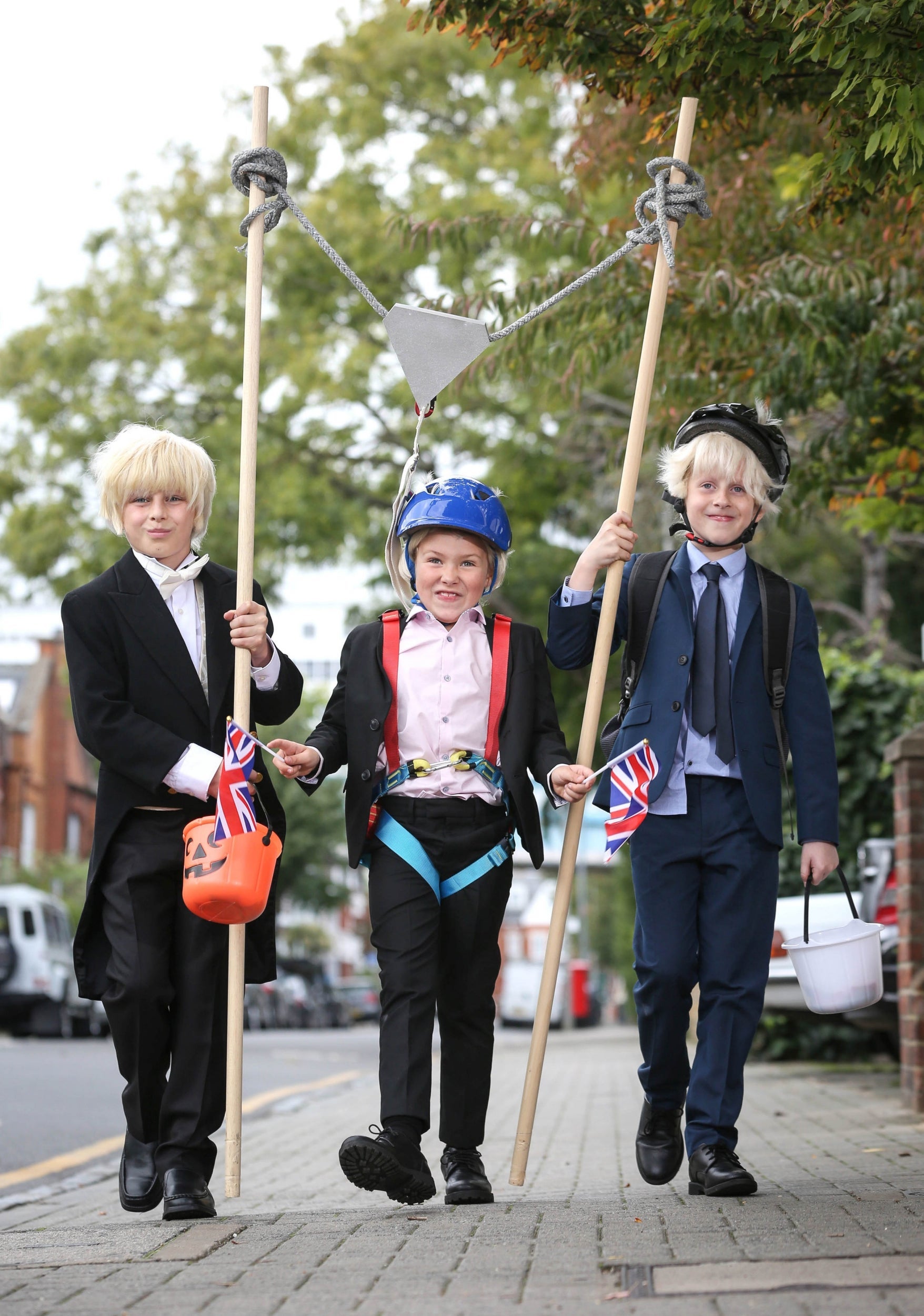 Jamison McCarthy (10), Jack Waterson (seven) and Presley Kempson (10) dress as three versions of the prime minister for Halloween