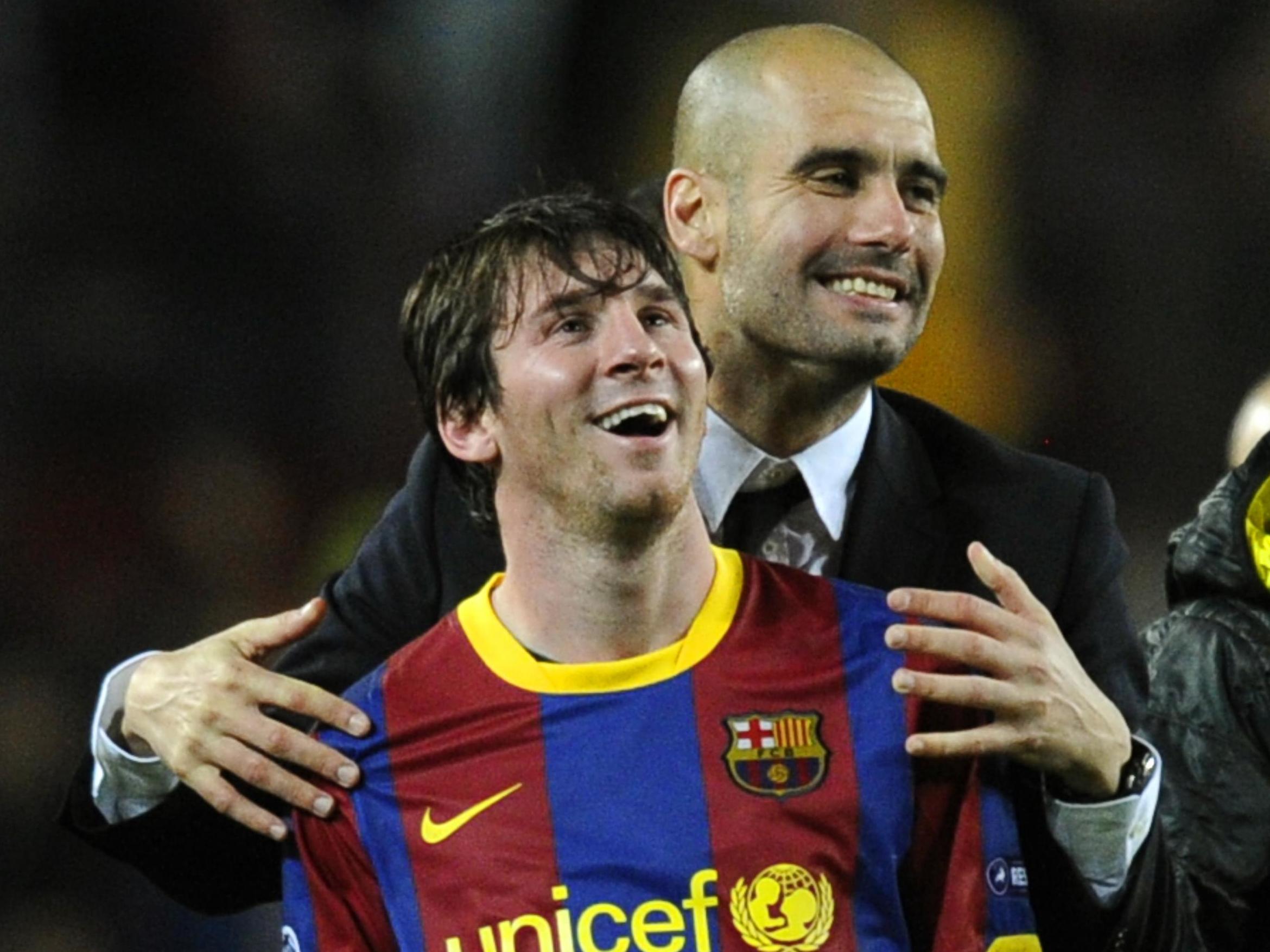 Pep Guardiola celebrates with Barcelona's Lionel Messi