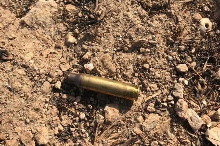 A casing for a live 5.56mm round, photographed on the hill above Kafr Qaddum on 19 July 2019. (Supplied)