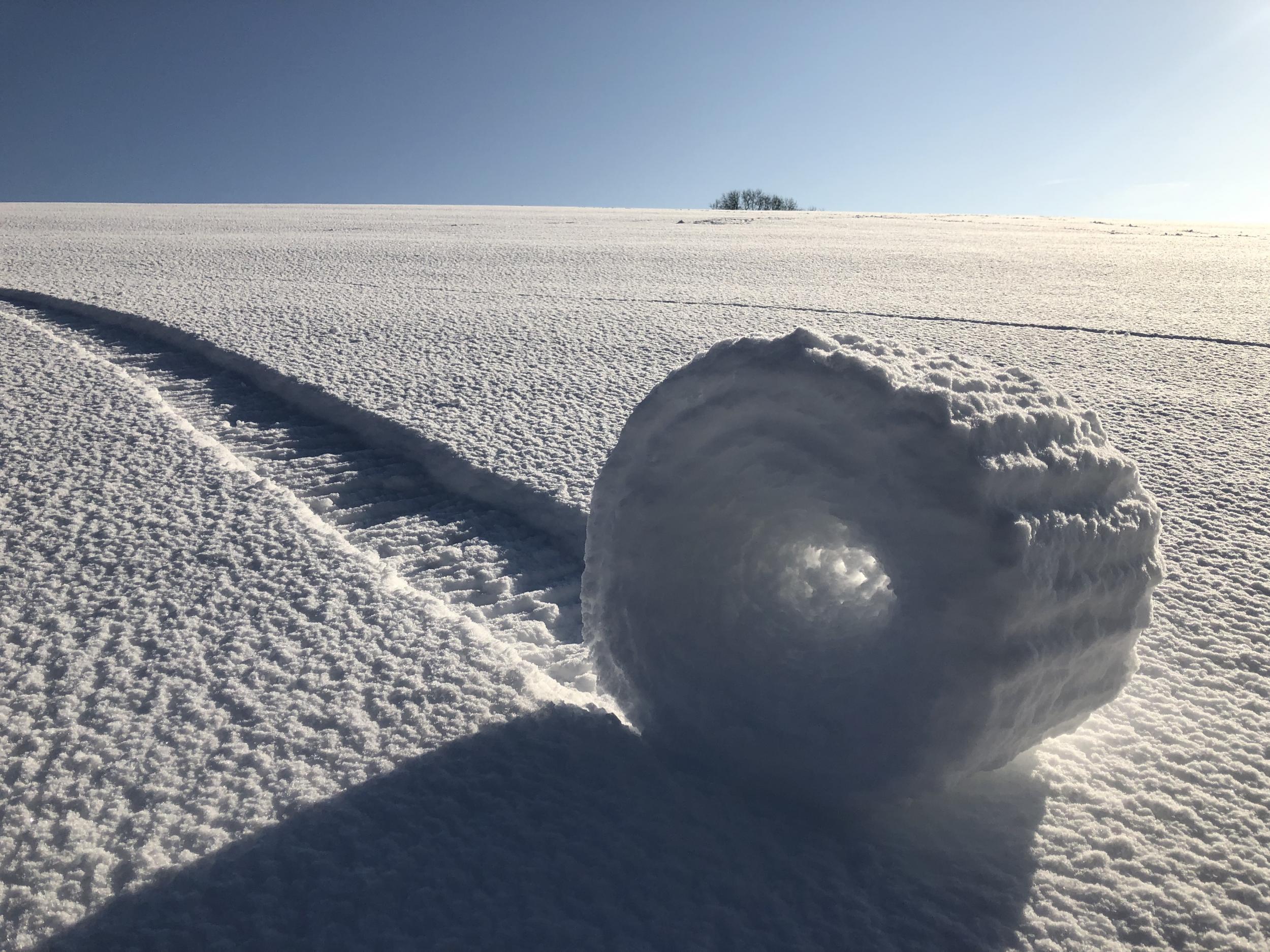 2nd RUNNER-UP: Conditions have to be just right for snow rollers to occur: a smooth, un-vegetated hillside, such as in this case near Marlborough, enhances the chance of them being formed. A layer of thin snow, settled atop existing ice and not sticking to it, combined with specific temperature, moisture level and wind speed, are fundamental to the creation of these natural oddities